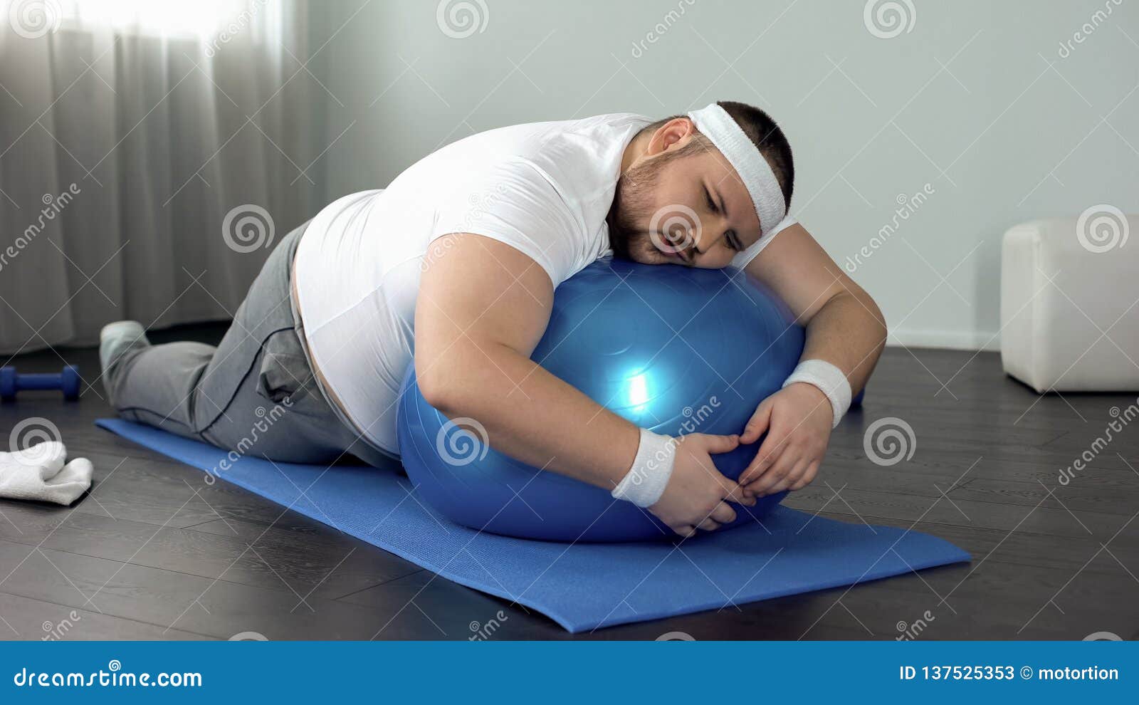 weak-willed fat man relaxing on fitness ball, home workout break, laziness