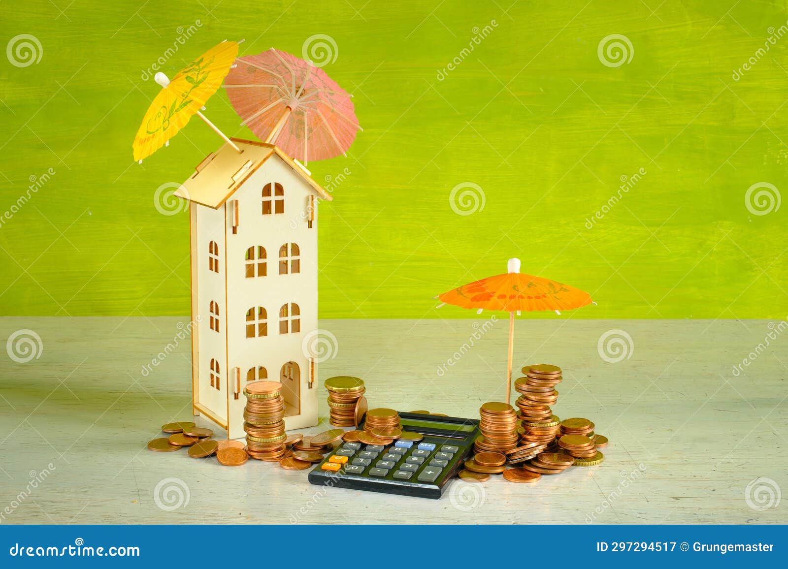 wealth management, assest mangement concept with pocket calculator,stacks of money, a wooden house and multicolored umbrellas,