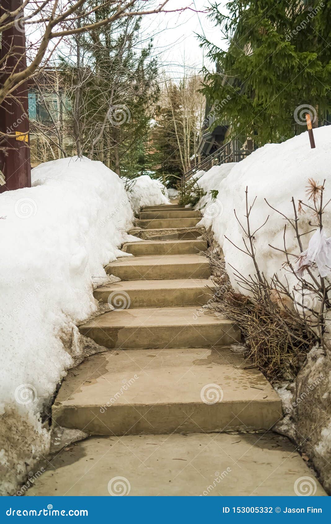 Weathered Concerete Outdoor Steps Amid Snow Covered Slope in Winter