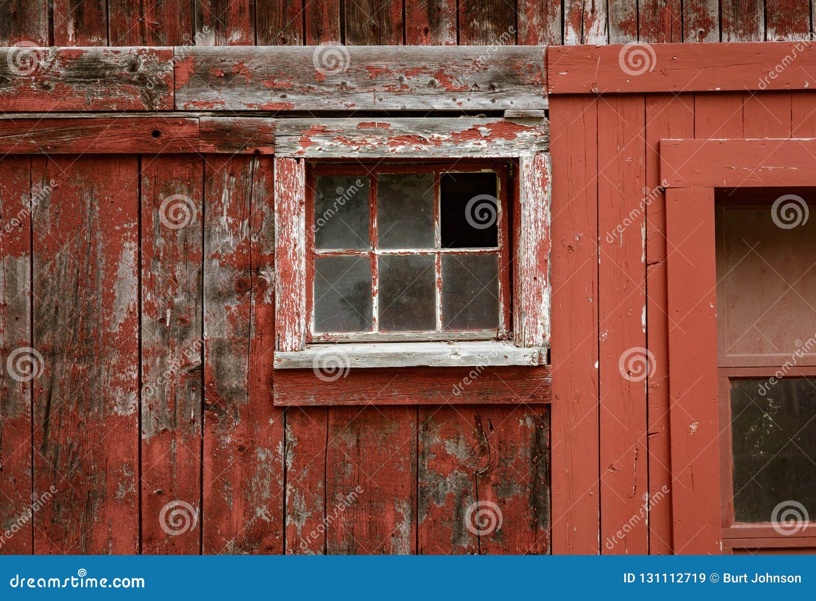 Weathered Red Paint And Broken Windows Are A Common Site On Barn