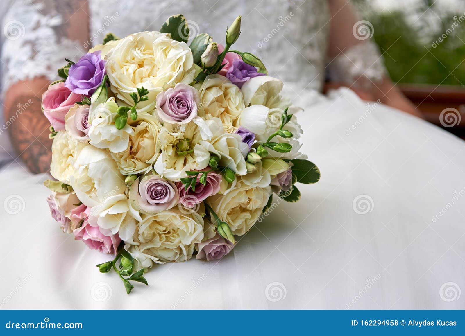 Wedding Bouquet in the Background of the Bride's Wedding Dress Stock ...