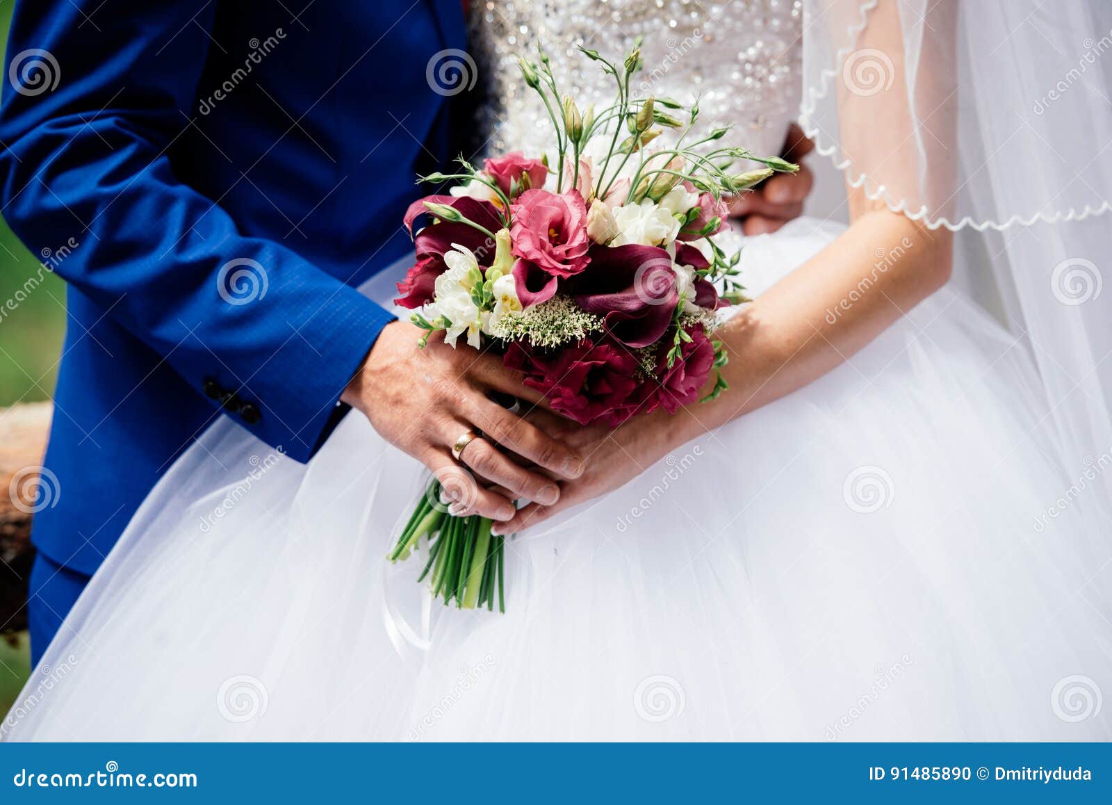 Wedding Bouquet of Burgundy Flowers in Bride`s and Groom`s Hands Stock ...