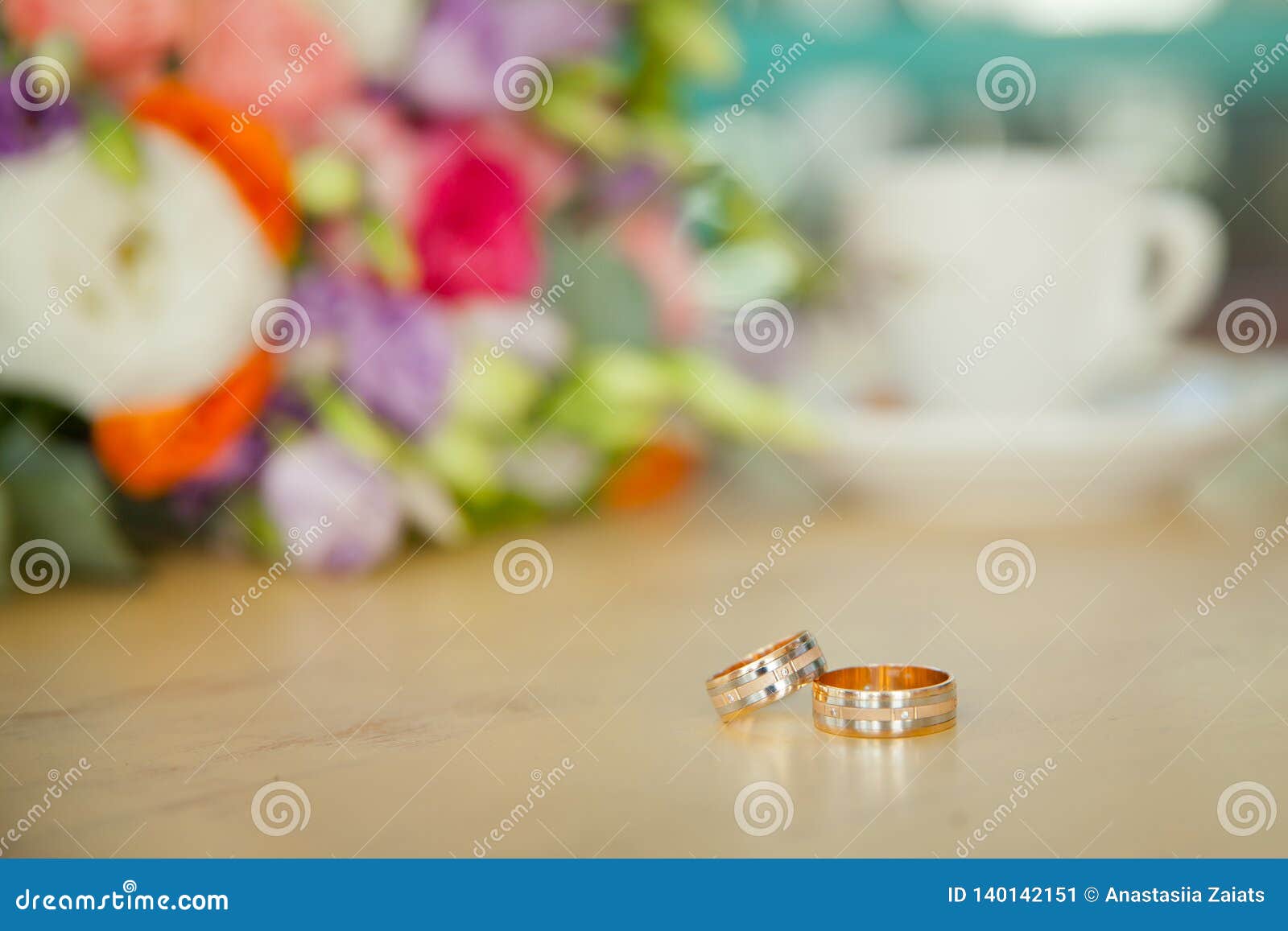 Wedding Bouquet and Coffee with the Wedding Rings on the Table Stock