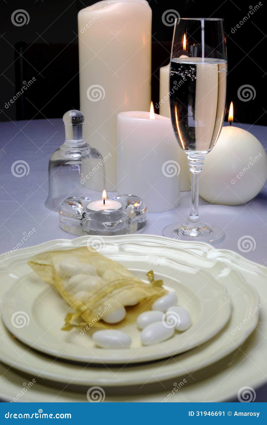 wedding breakfast dining table setting with sugar almonds on fina china with champagne flute
