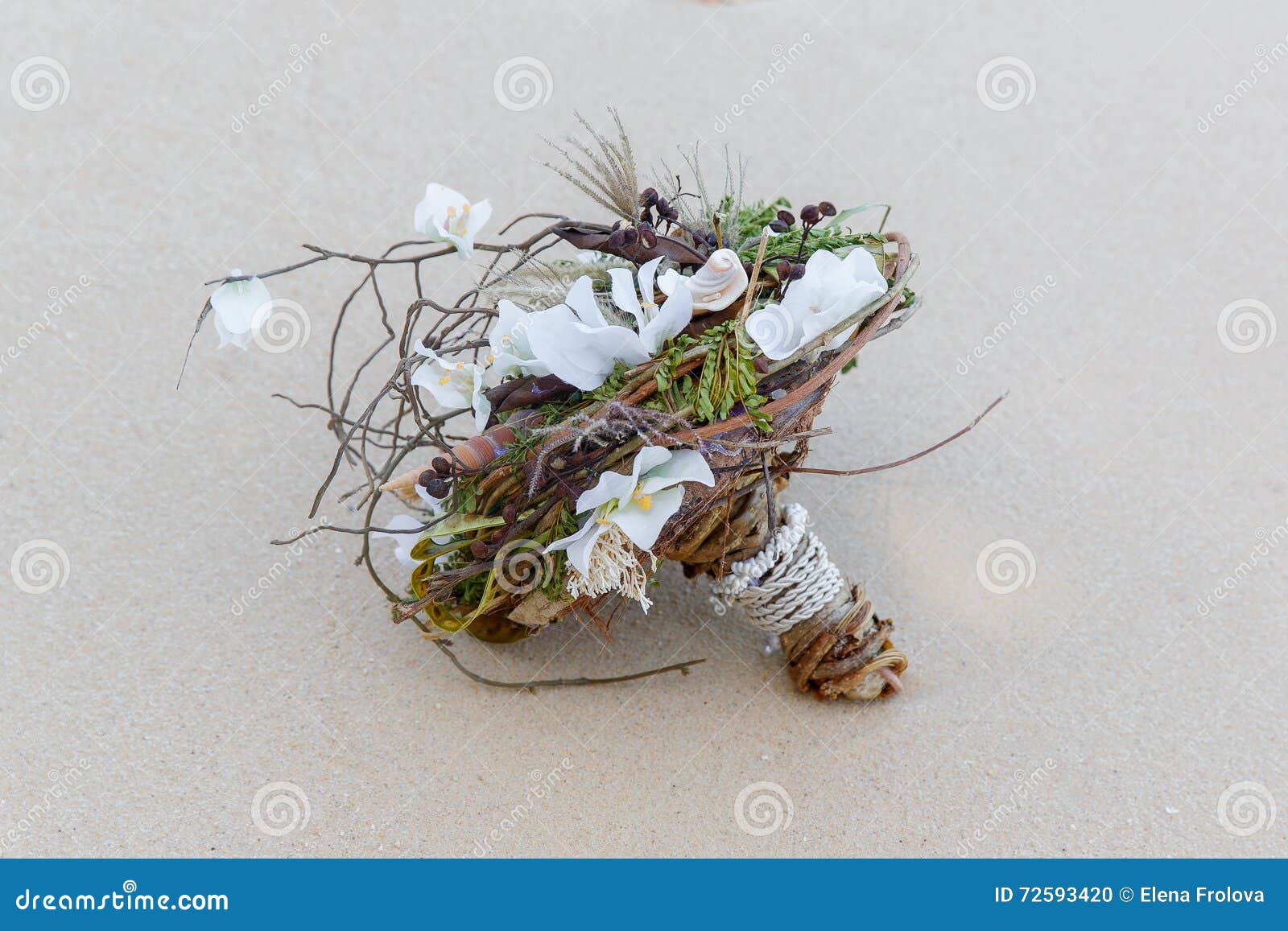 Wedding bridal bouquet made â€‹â€‹of shells and pearls and other natural materials on the sand. Wedding and honeymoon in the tropics.