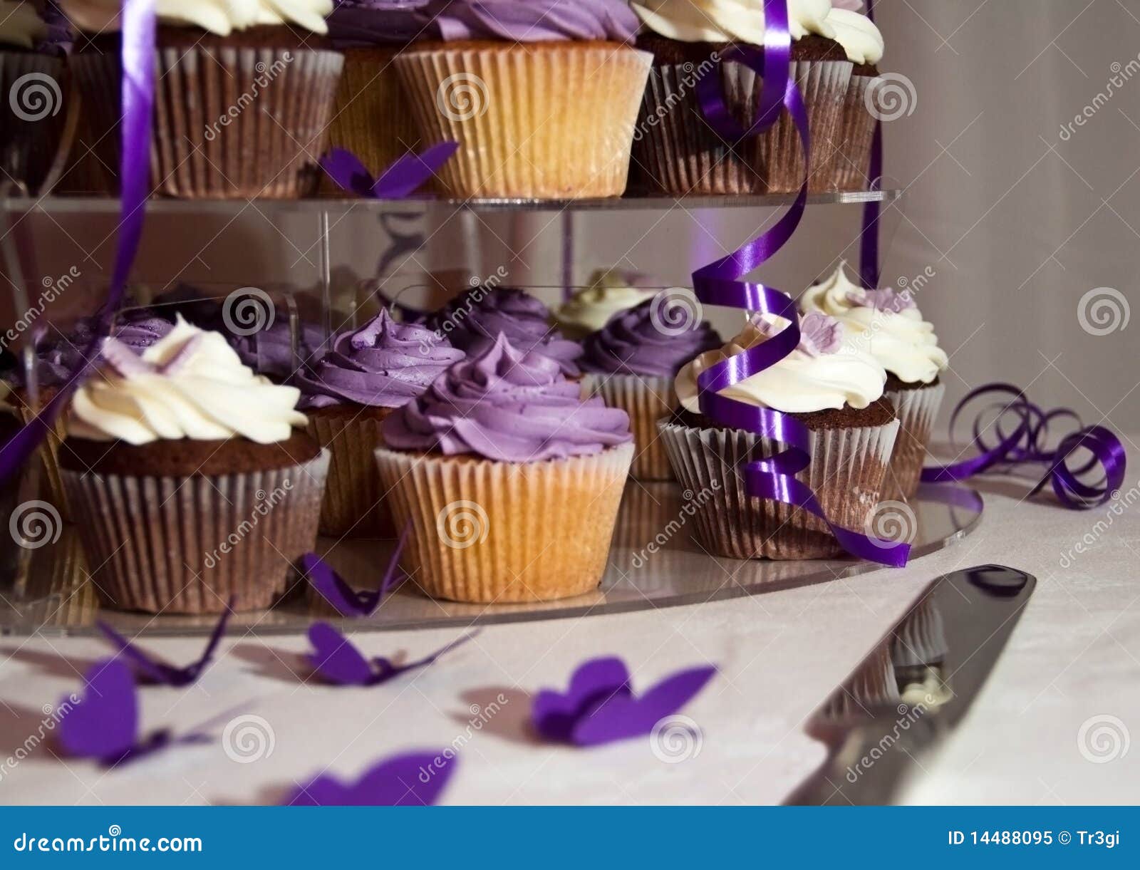 Wedding Cake closeup - Bunch of Colorful Cupcakes. Wedding Cake - Bunch of Yummy Traditional Colorful Chocolate Cupcakes on a table with a Knife