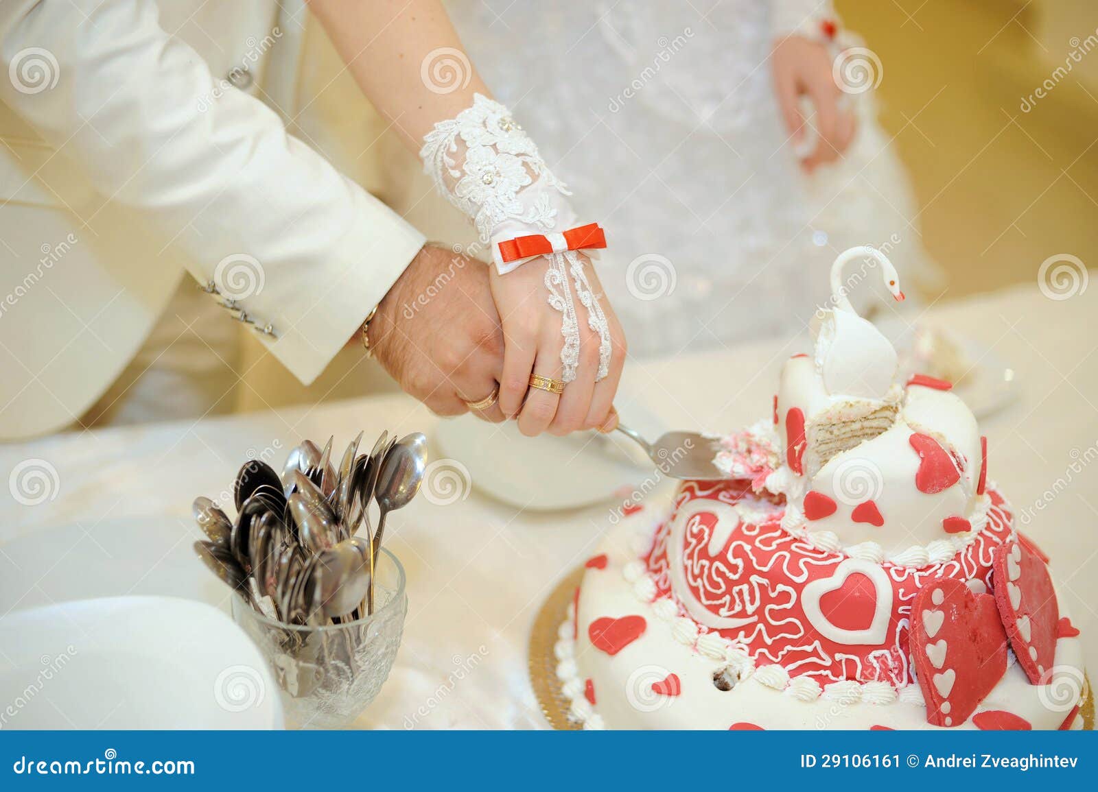 Wedding Cake with Swan. Couple cutting beautiful wedding cake