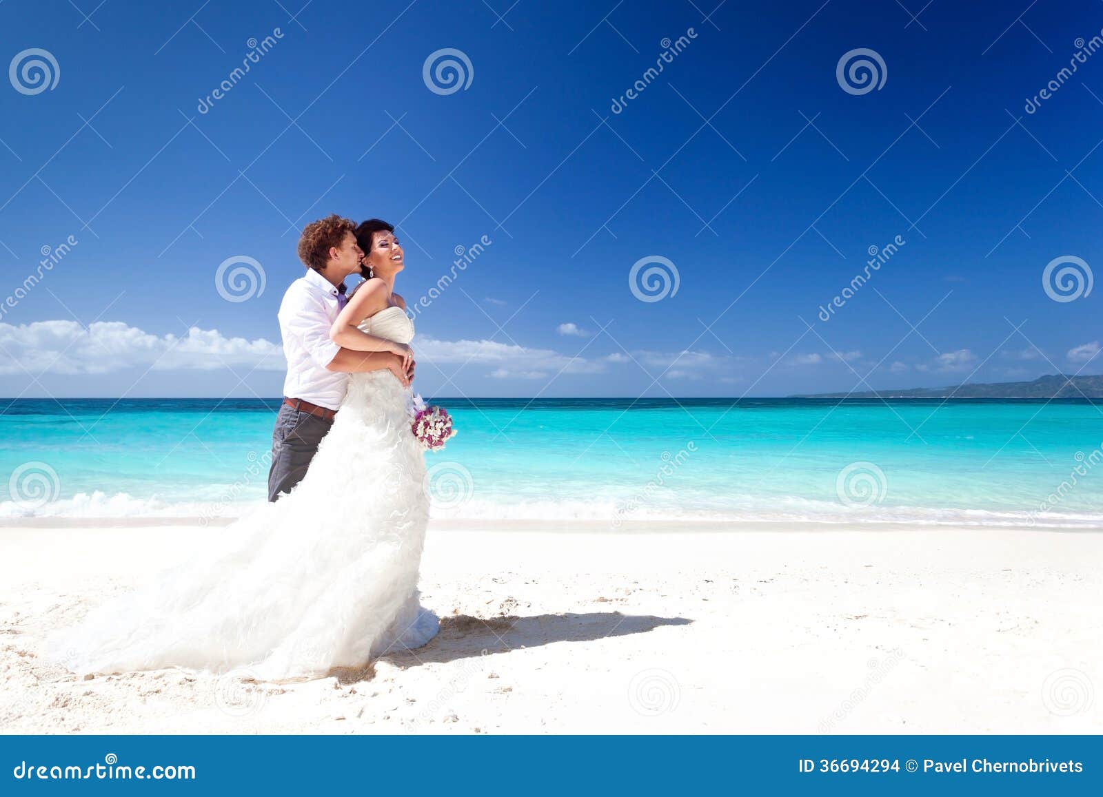 Wedding couple on beach stock photo. Image of purple