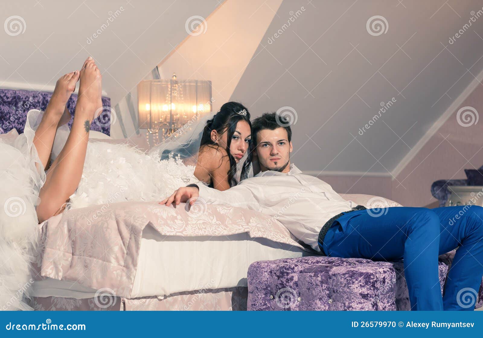 Wedding couple on a bed stock photo. Image of marriage 26579970