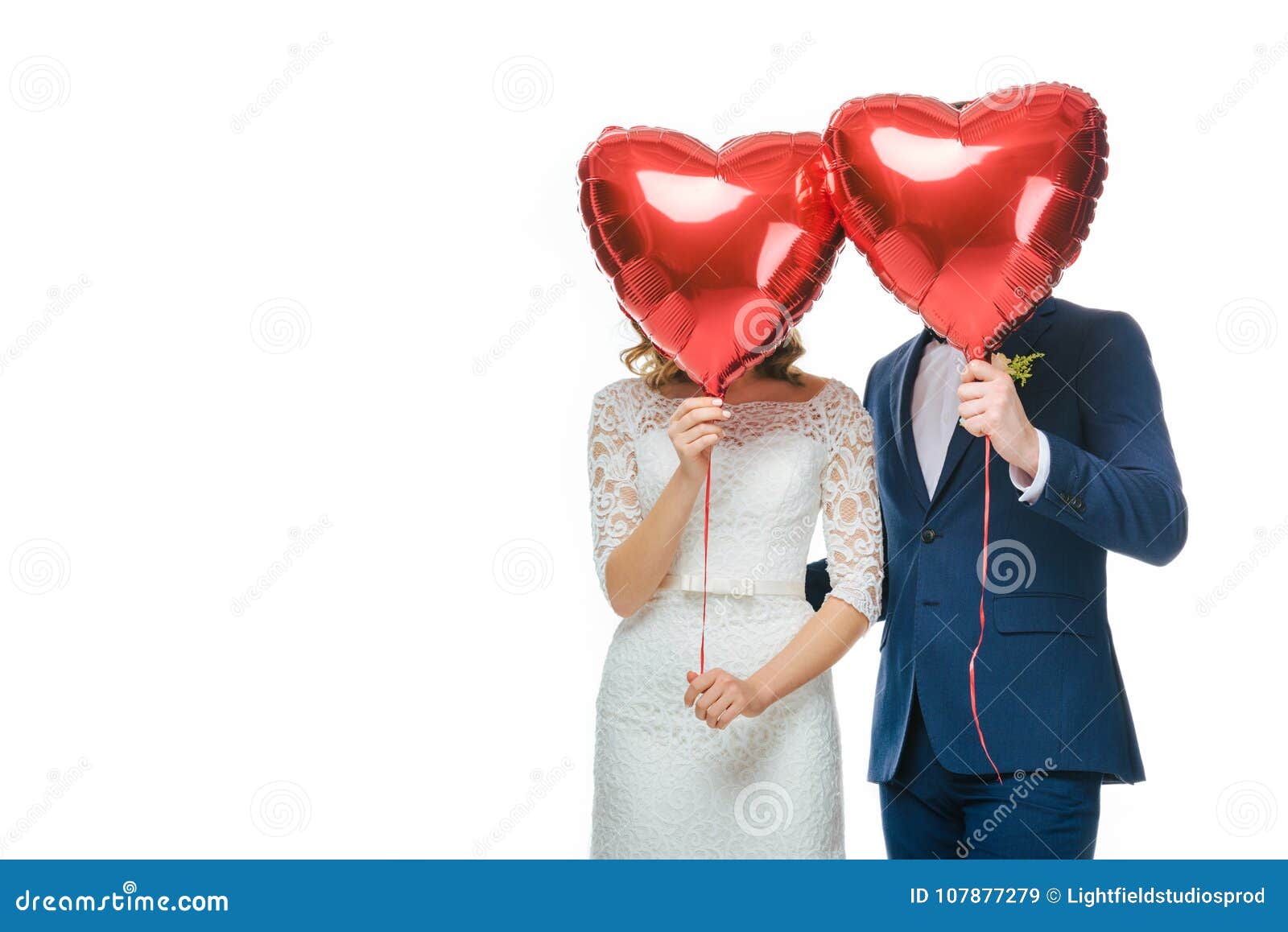 Wedding Couple Covering Faces With Red Heart Shaped Balloons Stock