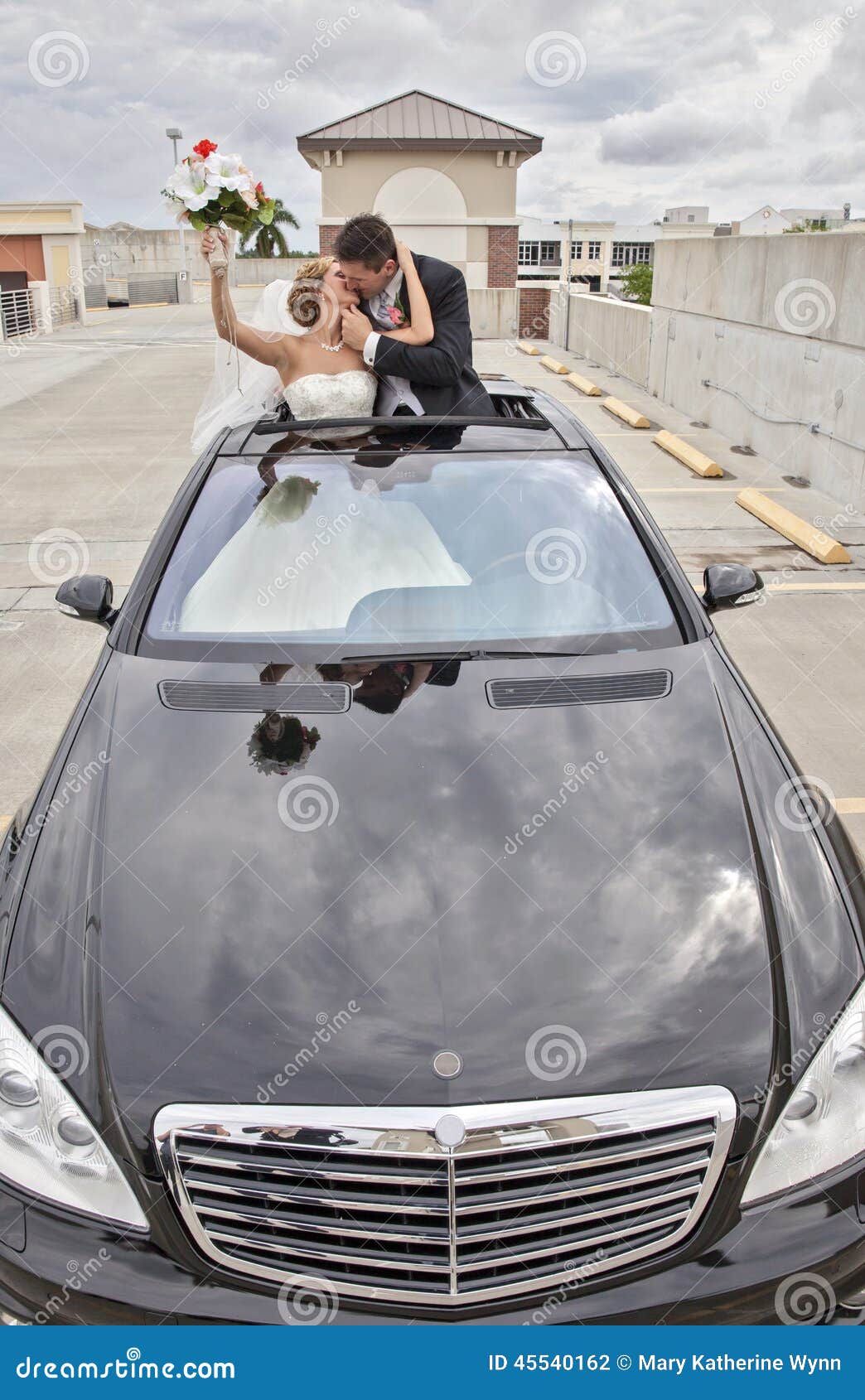 wedding couple in limousine sunroof