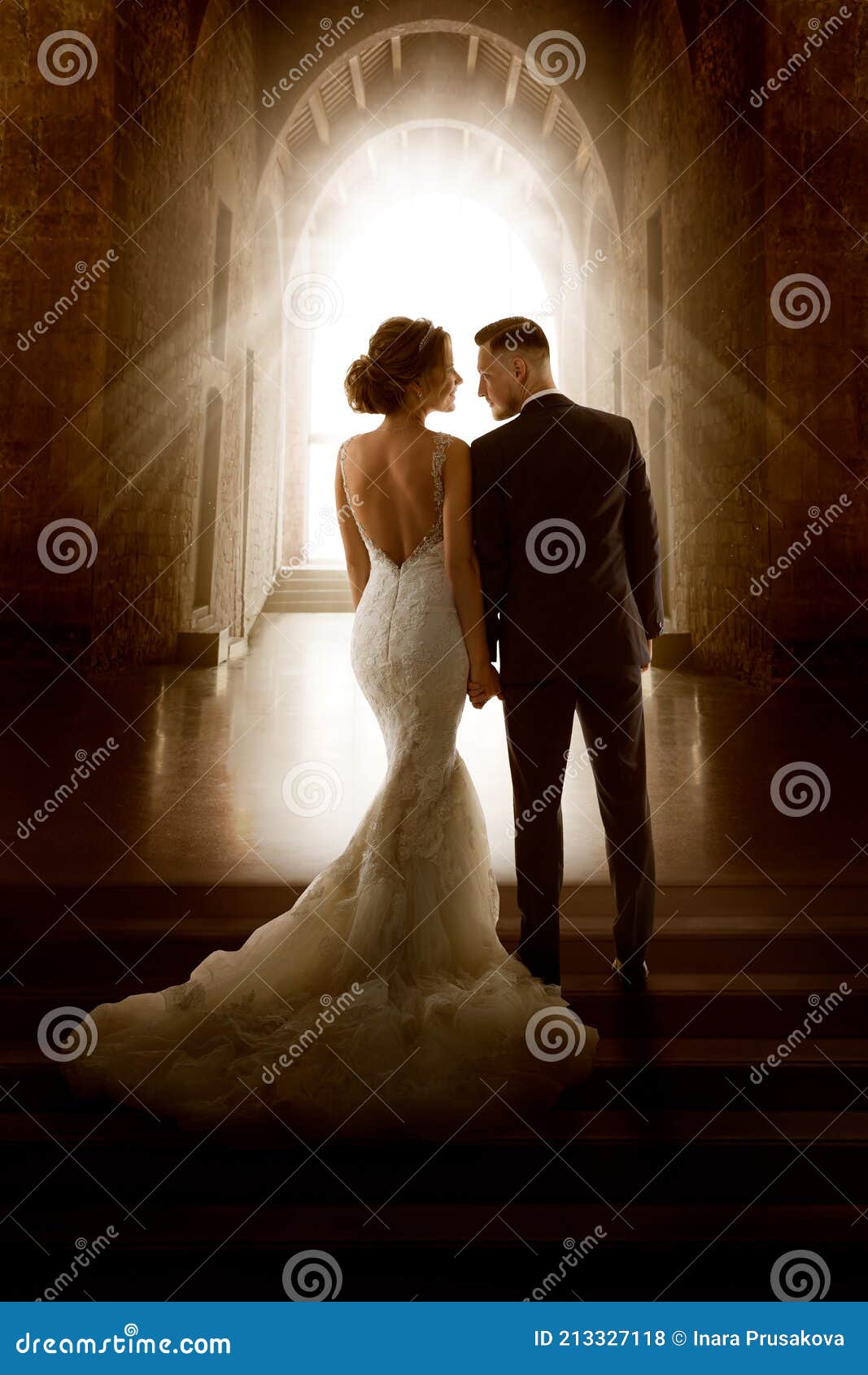 wedding couple in love back view walking down aisle church. newly wedded bride groom. wedding day ceremony
