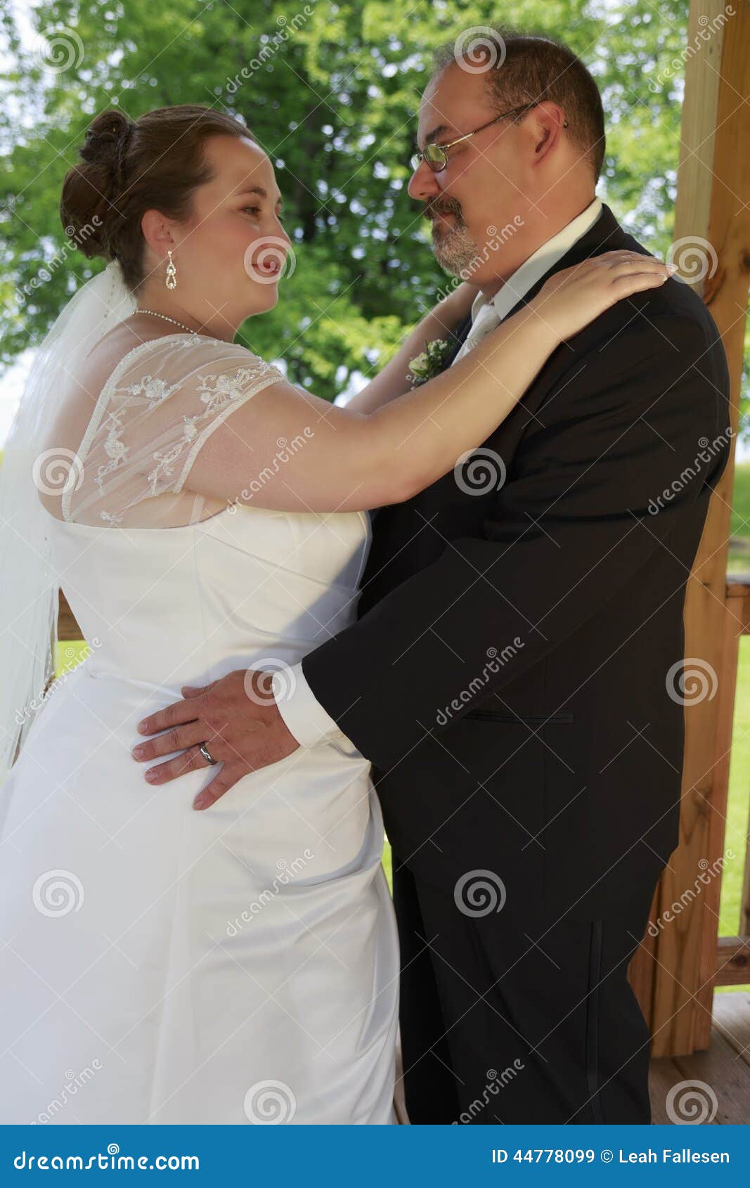 wedding couple pose average caucasian bride groom embrace their portait her hands his shoulders his hands 44778099