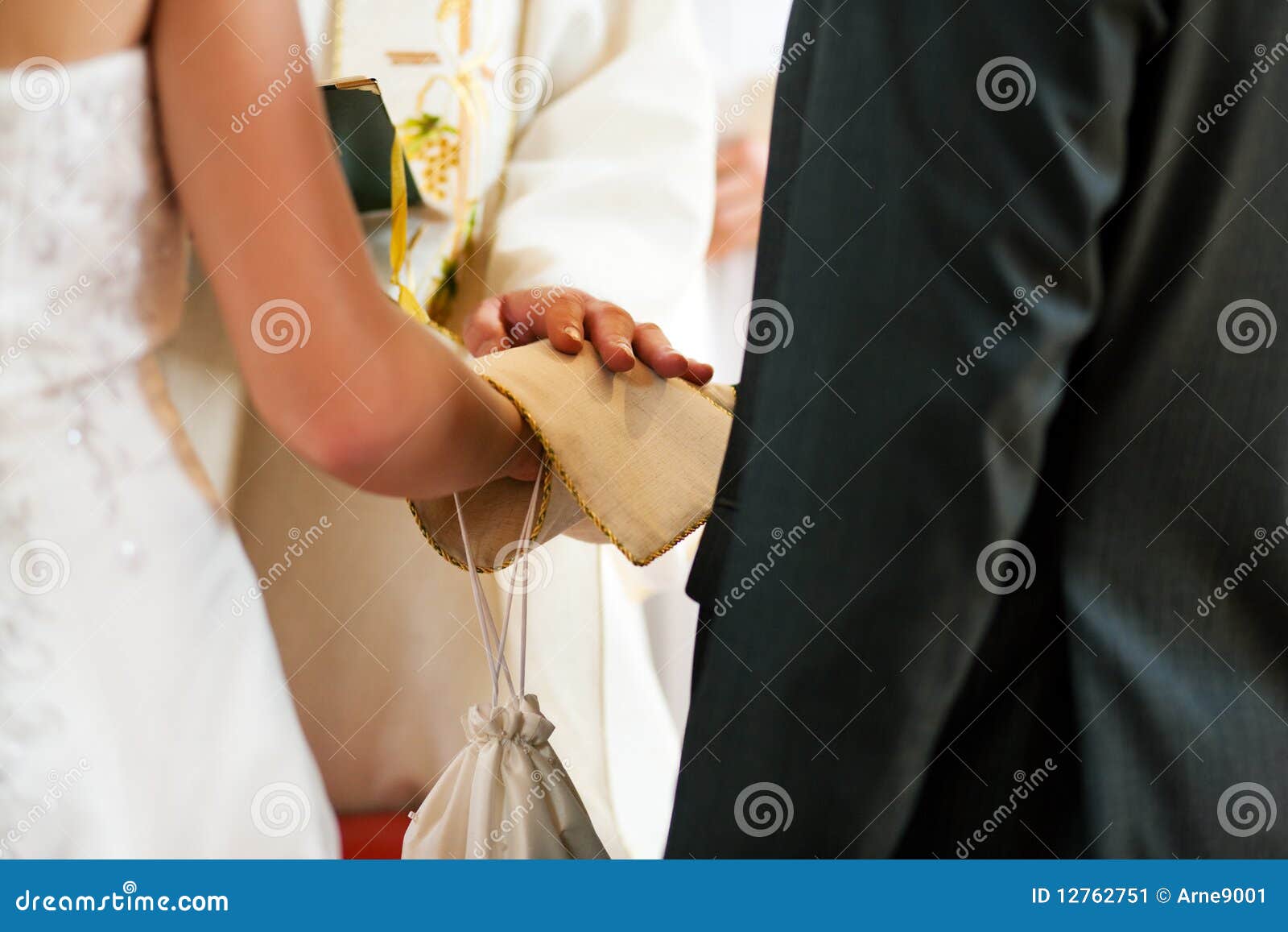 wedding couple receiving blessing from priest