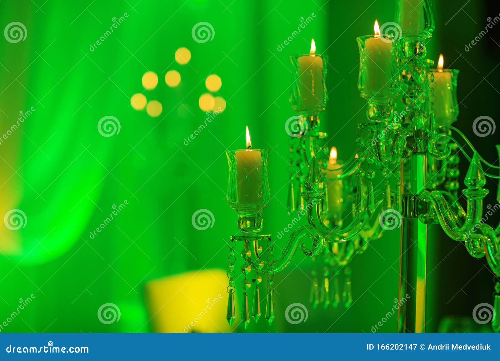 Wedding Decoration. Crystal Candelabra with Candles in Green Light