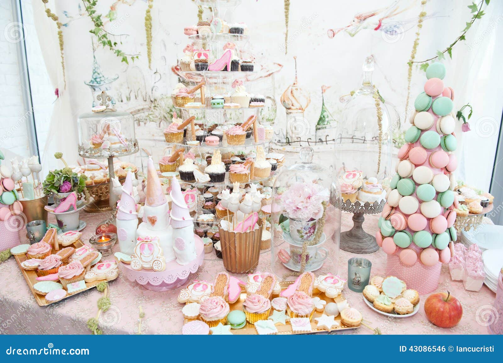 wedding decoration with pastel colored cupcakes, meringues, muffins and macarons