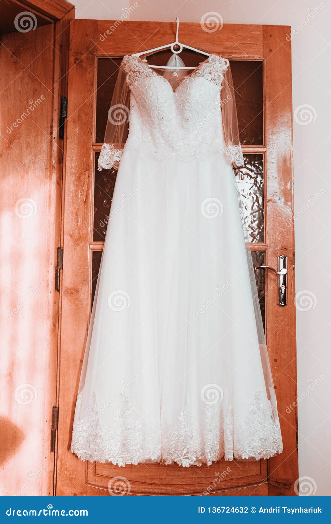 Wedding Dress on Hanger on a Wall, Beautiful Gown Stock Photo - Image ...