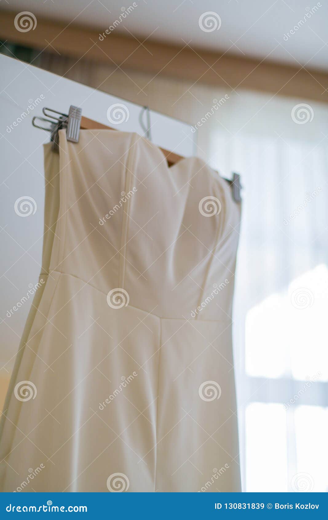 Wedding Dress Hanging on the Hanger on the Cabinet Door. Vertical ...