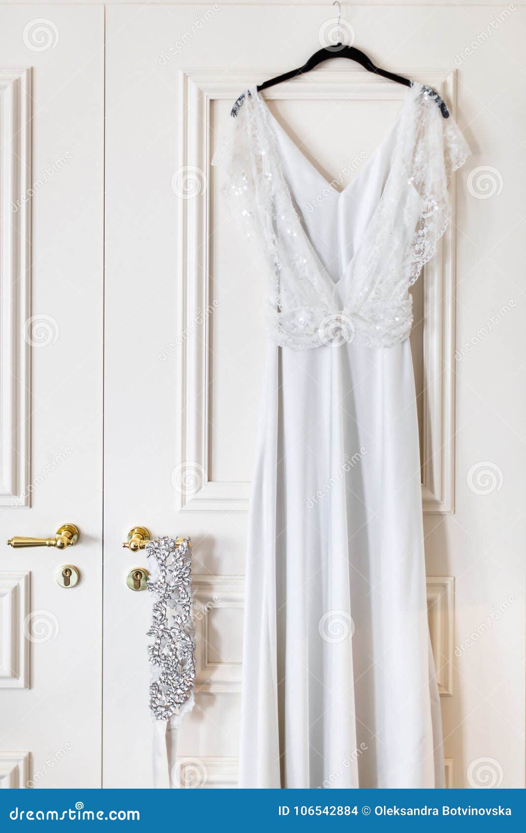 Wedding Dress Hanging on a Hanger in a Hotel Room on the Door Stock ...