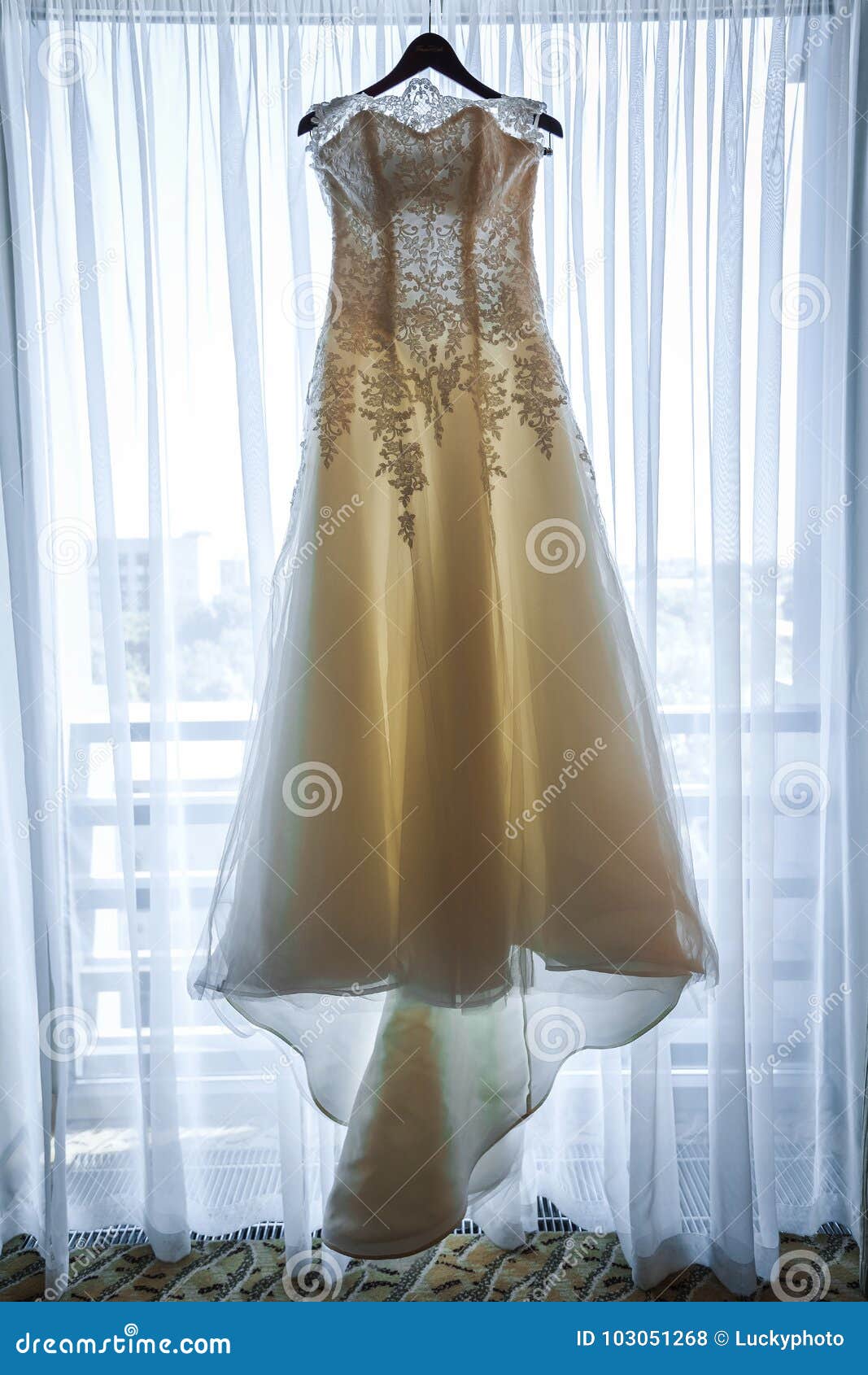 Wedding Dress Hanging on a Hanger Near Window Stock Photo - Image of ...