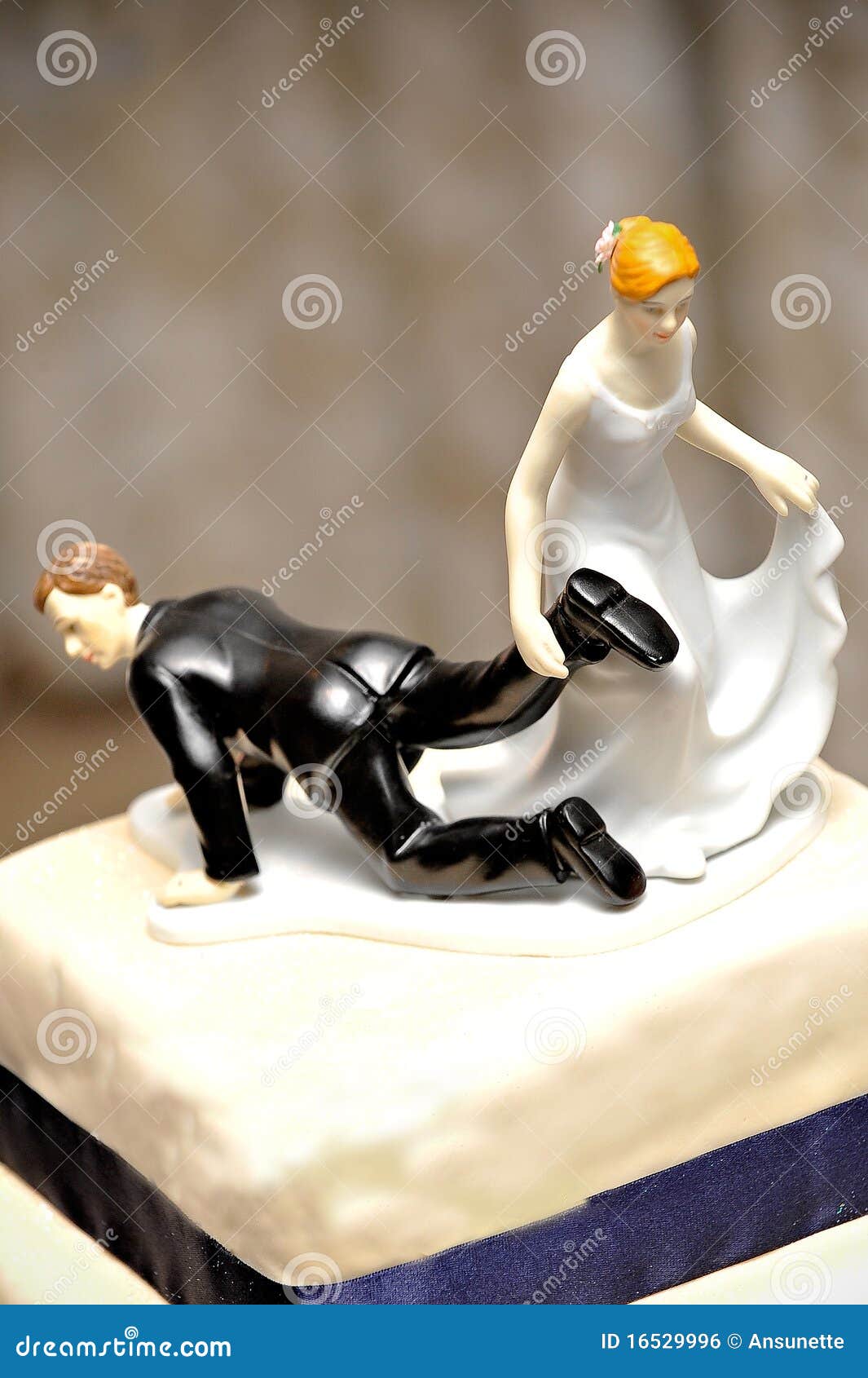 wedding figurine with bride dragging the groom