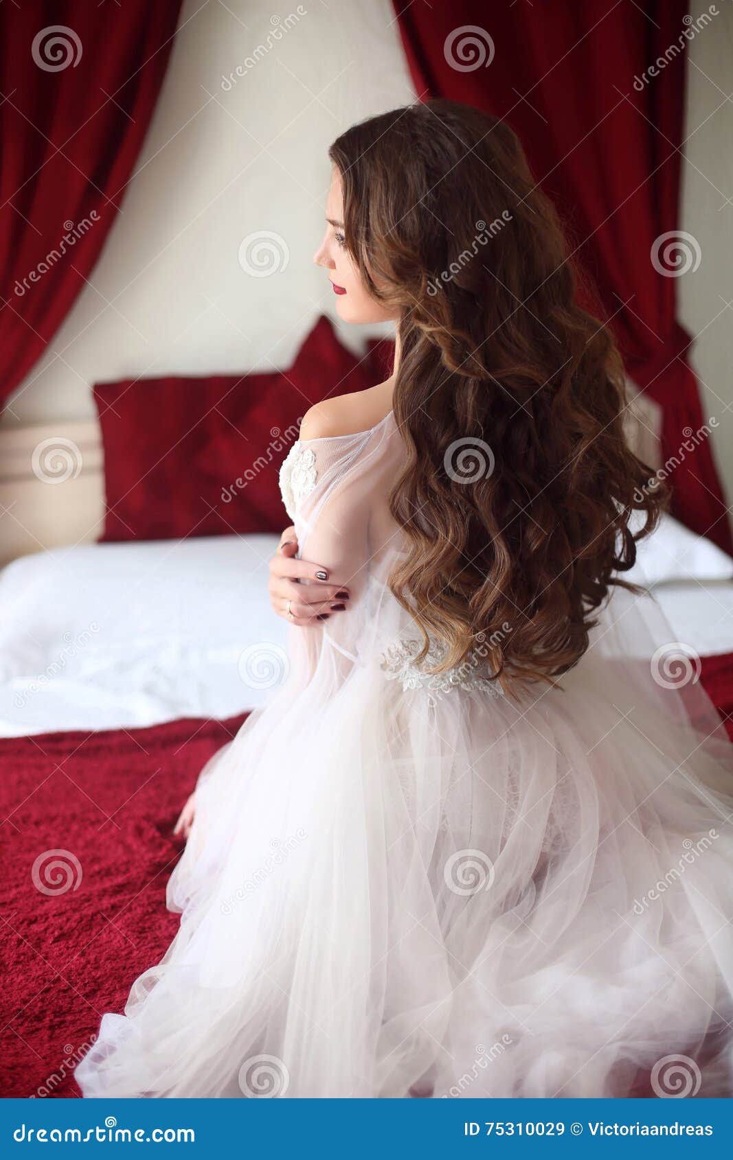 Elegant blond woman in beige dress posing on luxury sofa in royal interior.  Fashion beautiful sensual bride with makeup, curly hair style in luxurious  prom gown. Stock Photo | Adobe Stock