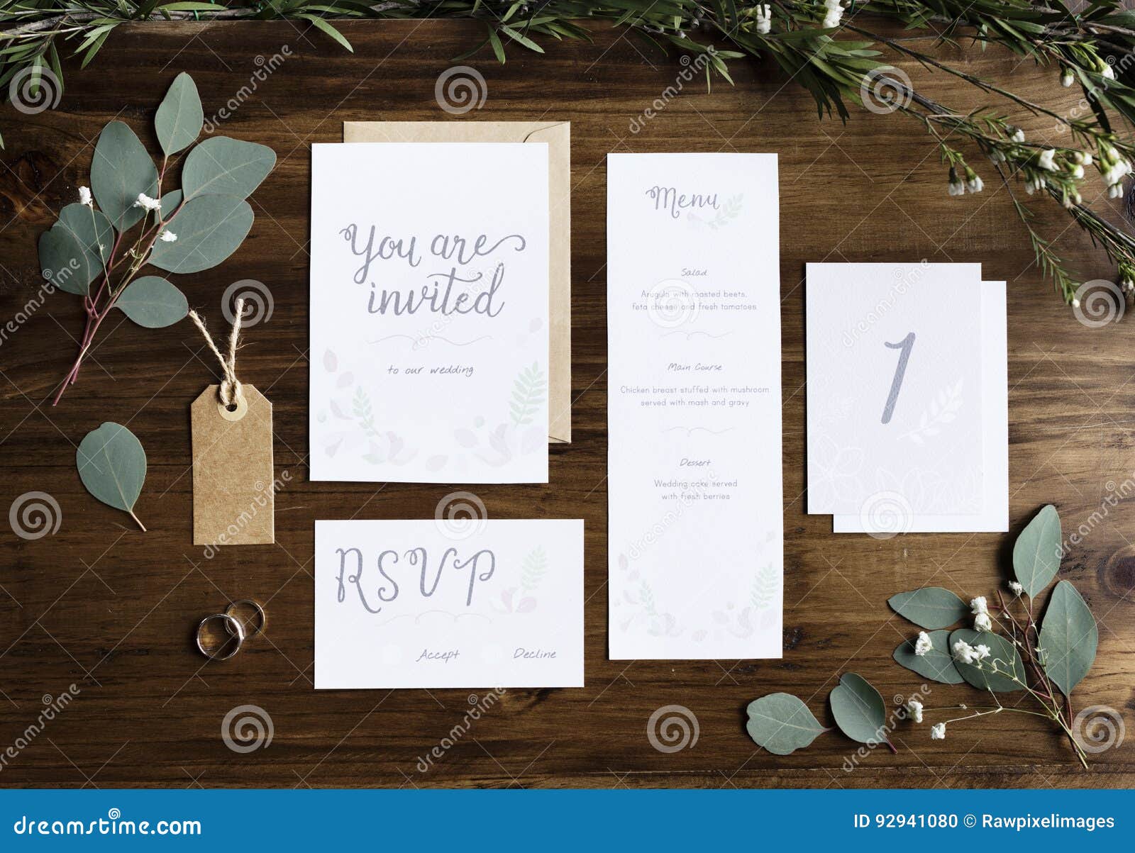 wedding invitation cards papers laying on table decorate with le