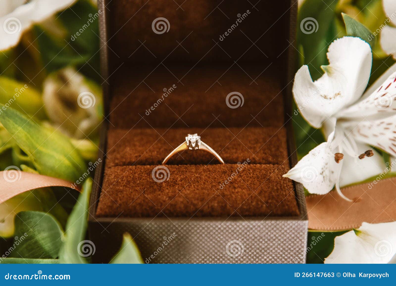 Wedding Ring in a Box Close-up, Gold Ring with a Diamond in Flowers ...