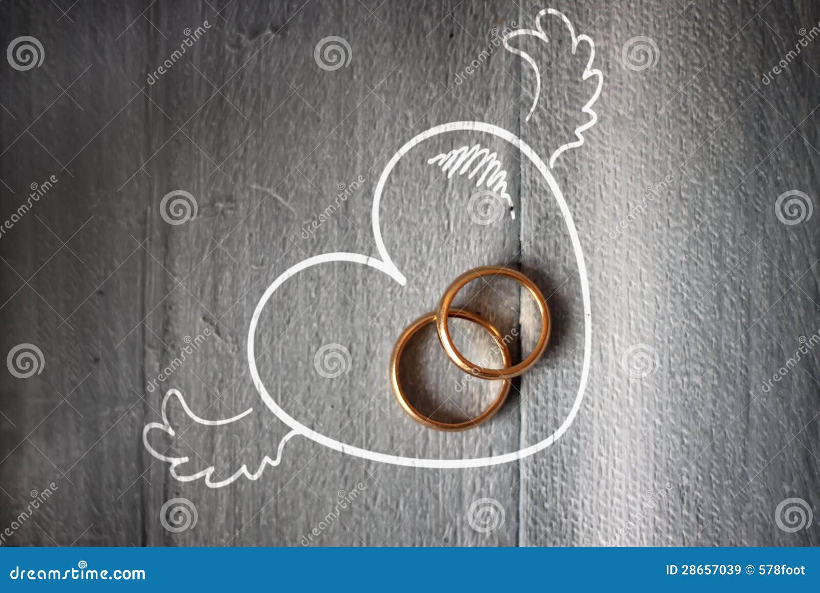 Wedding rings. Photo of wedding ring on wooden background