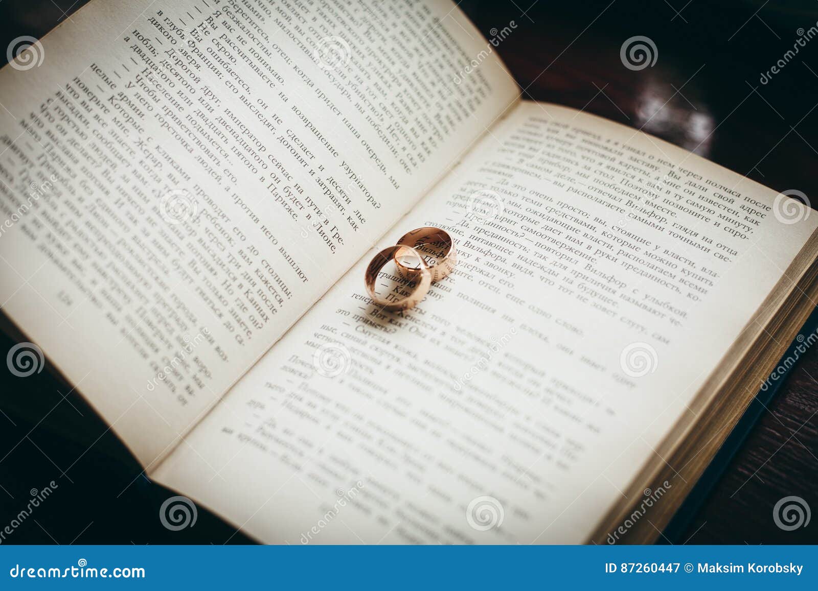 Wedding rings on a book stock image. Image of manicure 87260447