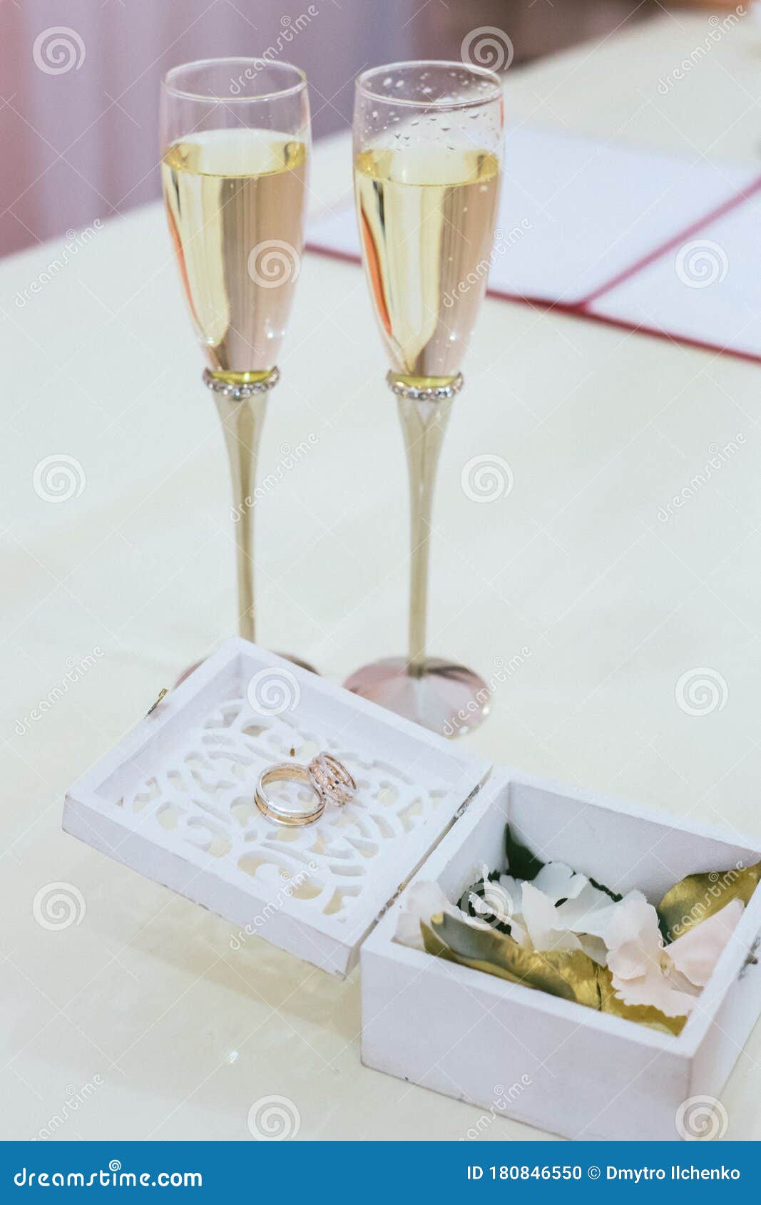 Wedding Rings in a Decorative Box, Two Glasses of Champagne Stock Photo