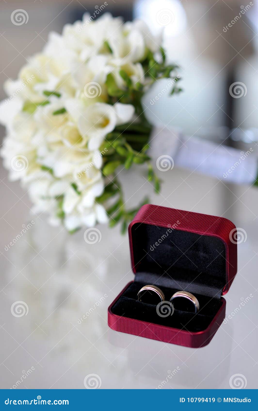 Wedding rings and flowers stock image. Image of engagement - 10799419