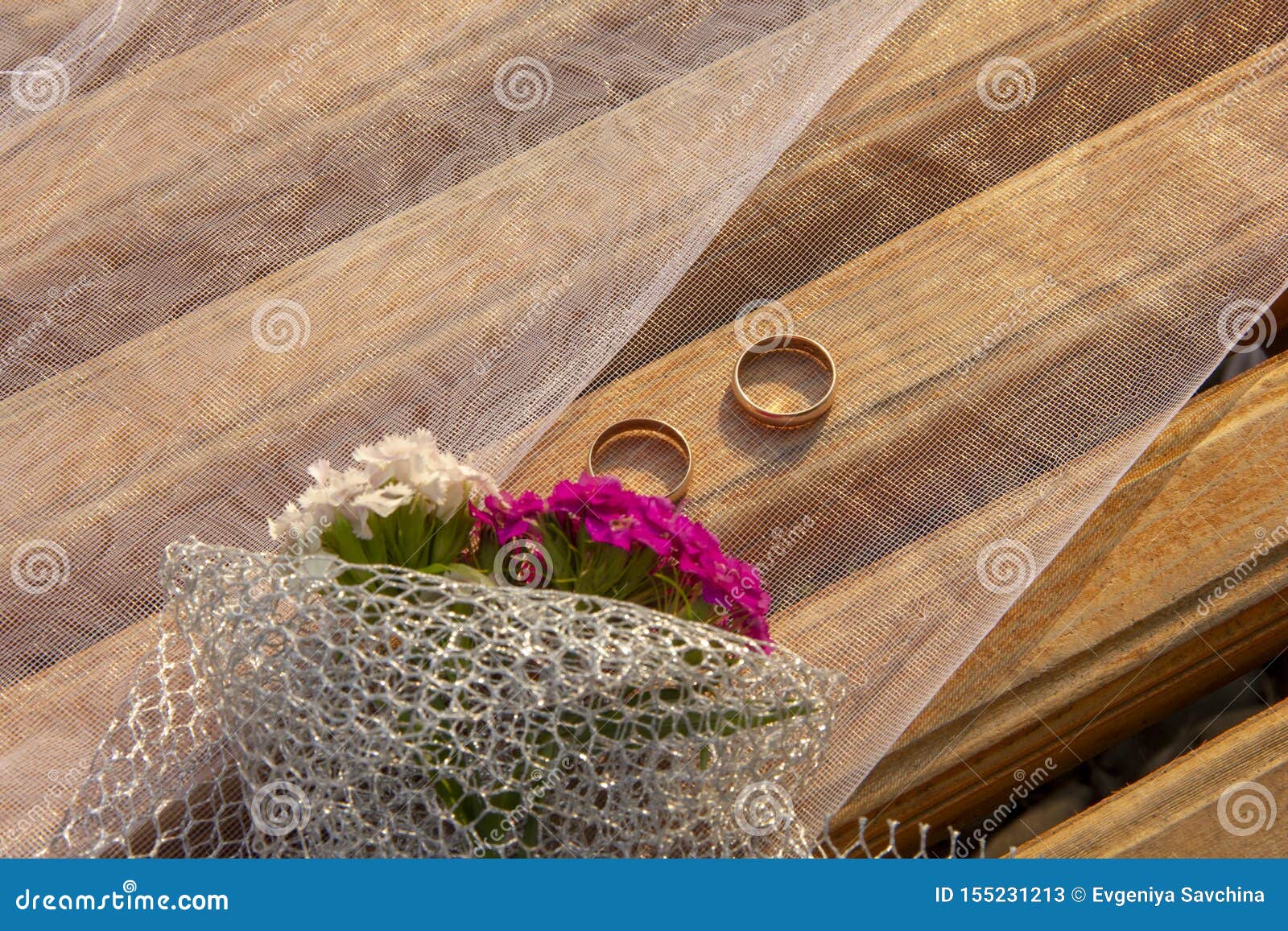 Wedding Rings Lie On A Grid. Wedding Rings Lie On The Flowers Of Carnations Stock Image - Image ...