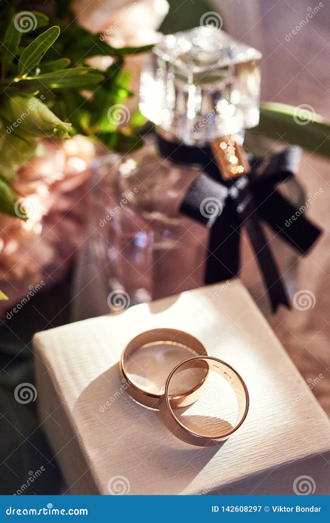 Wedding Rings Lie on the Table Near a Wedding Bouquet Stock Image