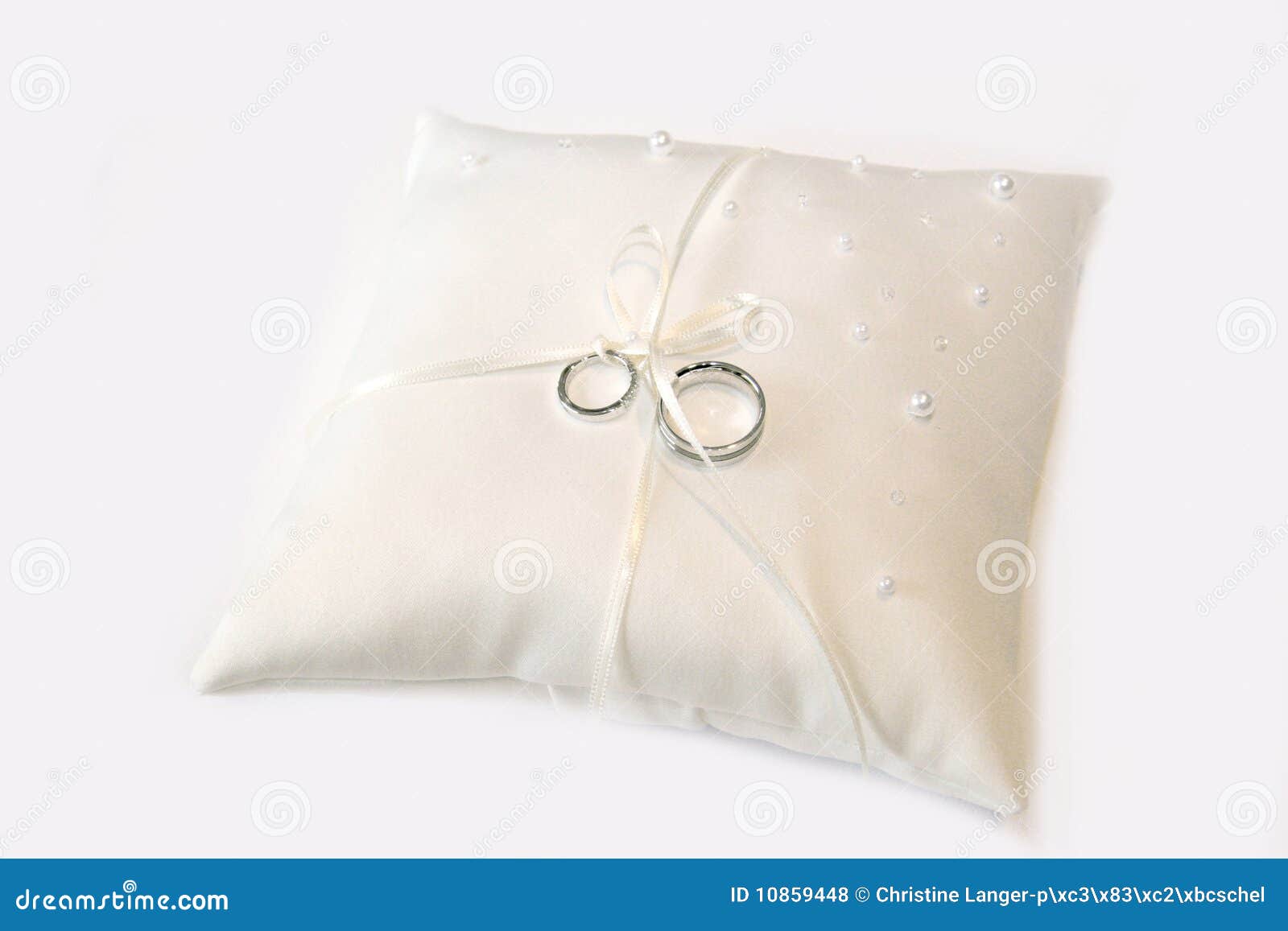 Wedding rings on a pillow stock photo. Image of couple 10859448