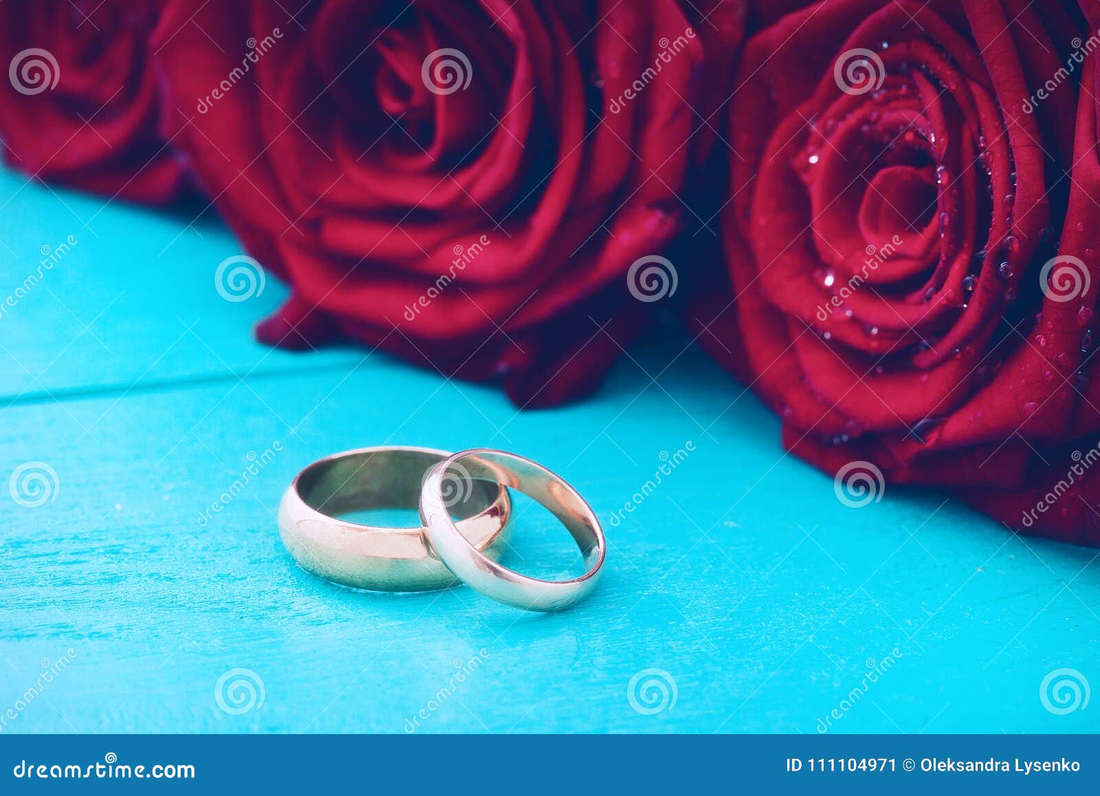 Wedding Rings and Red Roses. Wedding Bouquet on Blue Wooden Background ...