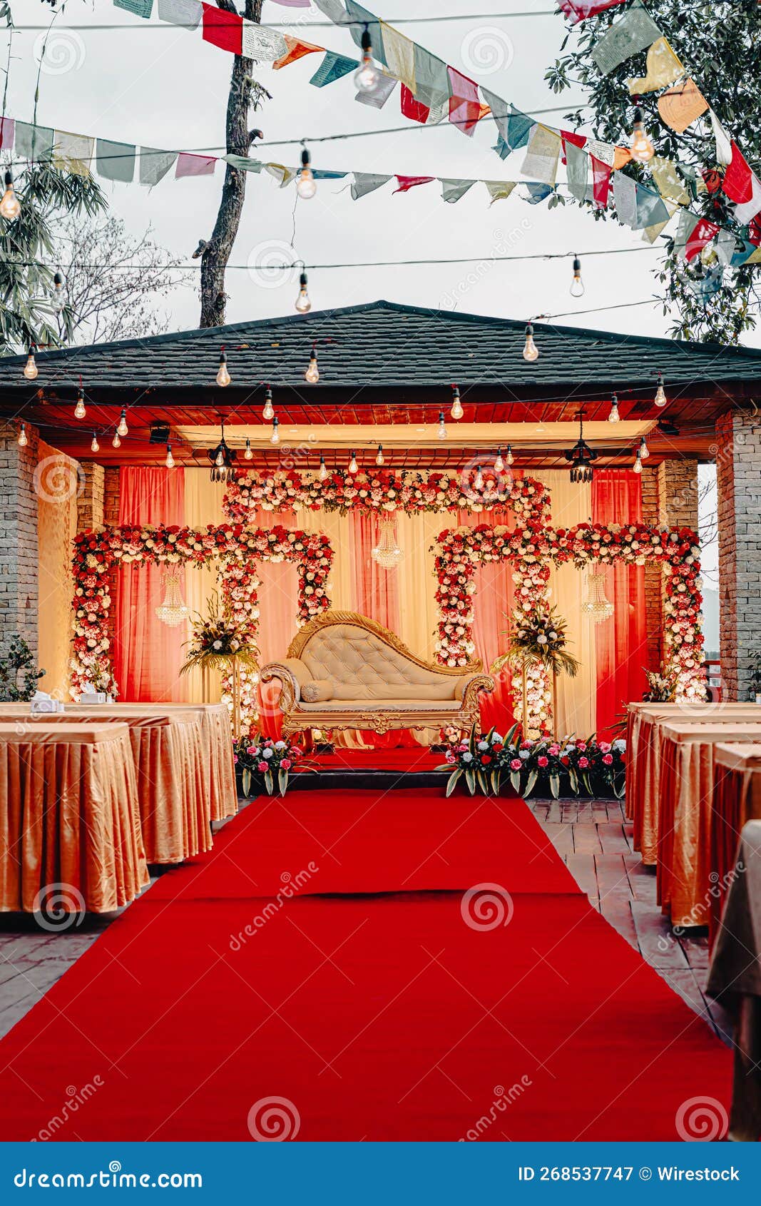 Wedding Stage Decorated in Red and Gold with White Garlands Stock Image