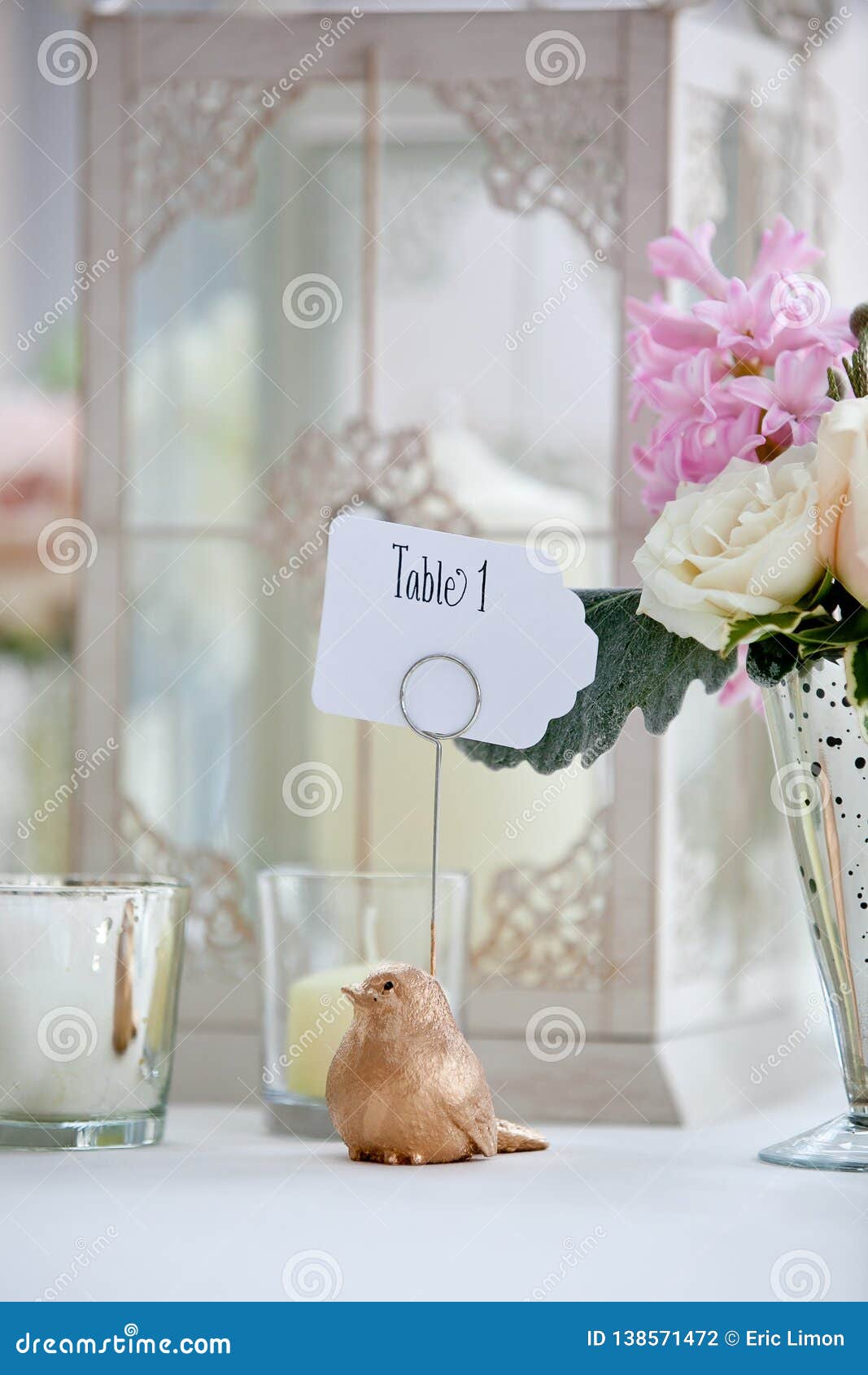 wedding table decoration series - pink and white bouquet of flowers and a bird holding a table 1 sign