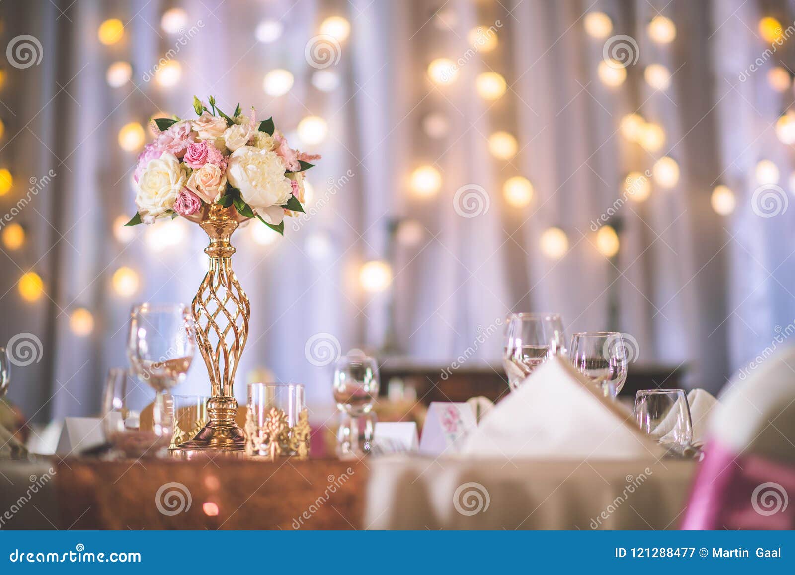 wedding table with exclusive floral arrangement prepared for reception, wedding or event centerpiece in rose gold color