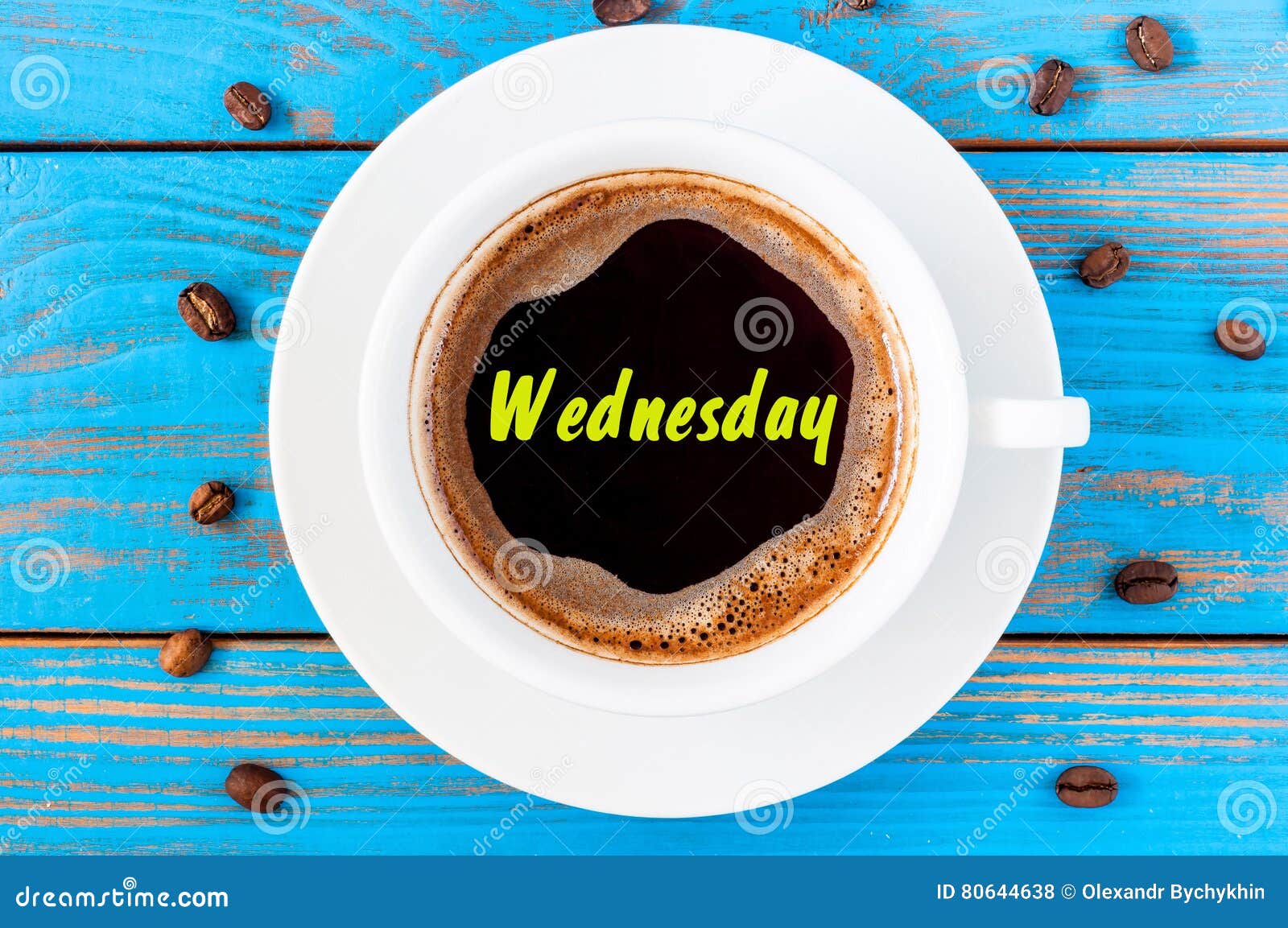 wednesday - inscription on coffee surface with cup of morning drink. good day start concept. top view