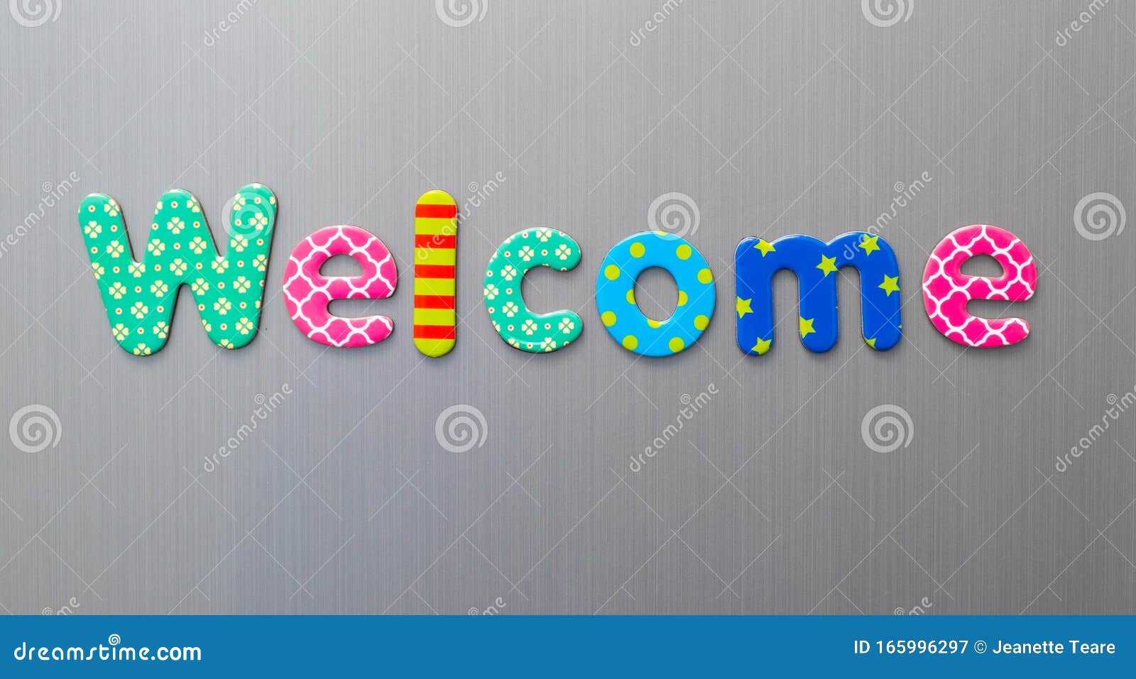 welcome word spelled out in bright colorful patterened letters on brushed metal background