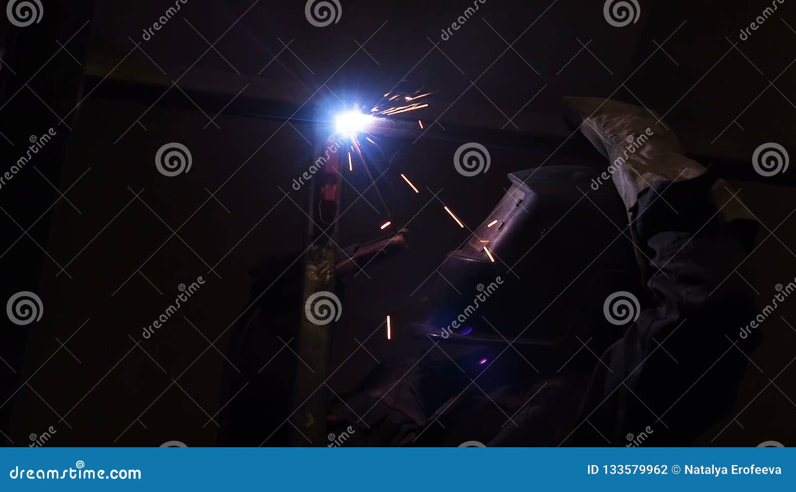 Welder Worker Performs Jump Welding. Worker Welder Performs ArcWelding