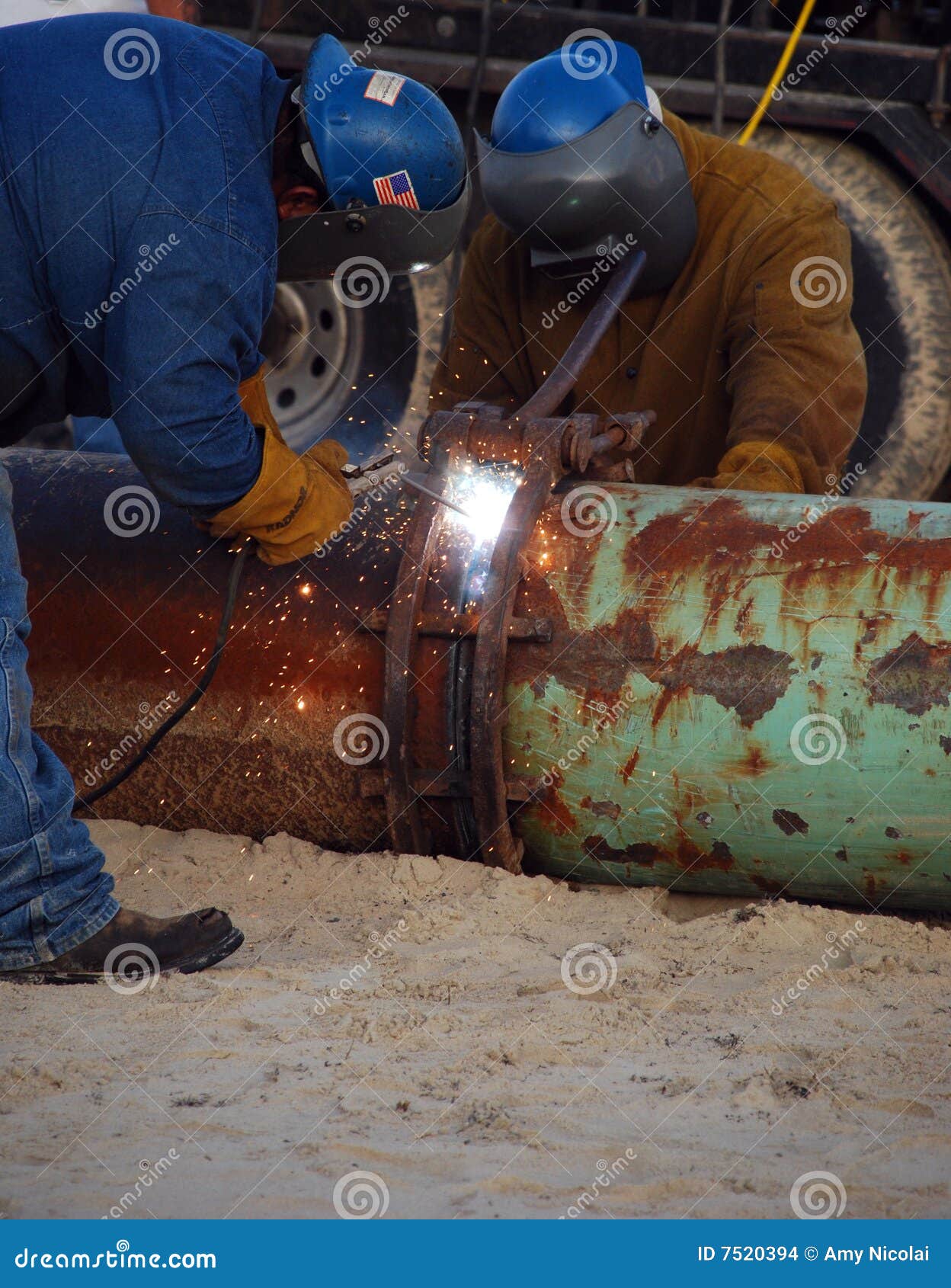 Welding two pipes together stock photo. Image of iron 7520394