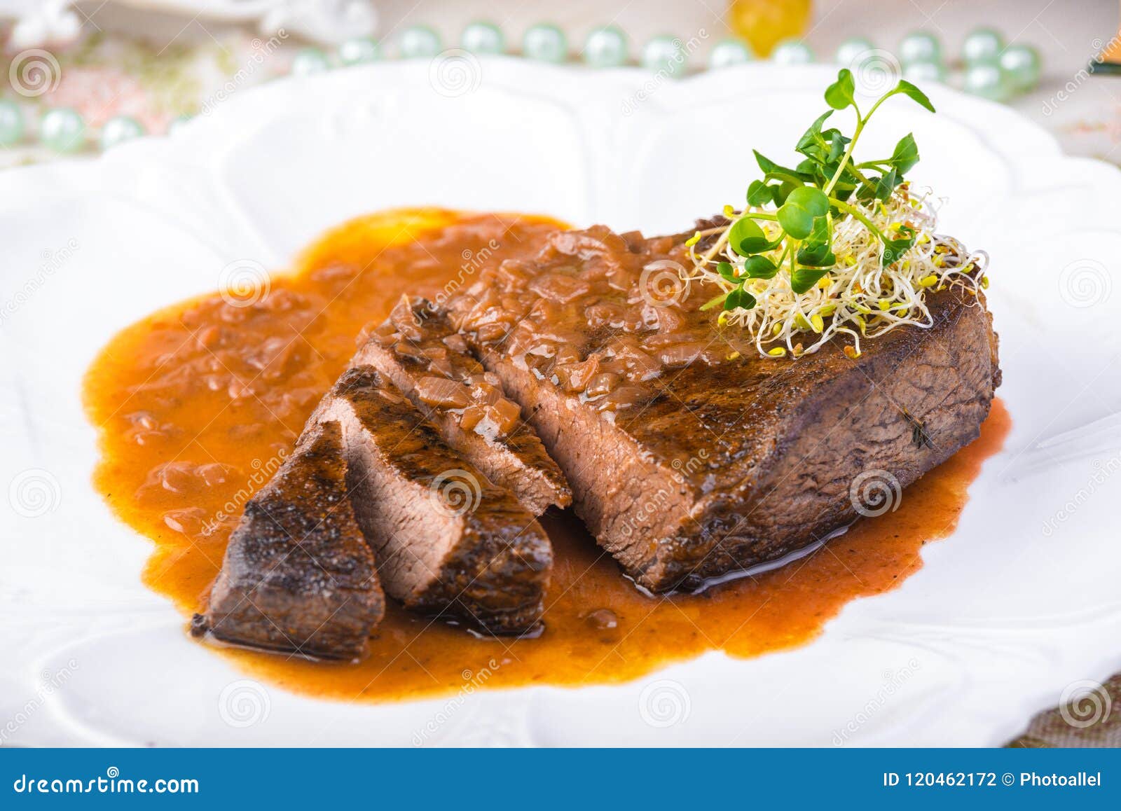 Welldone Grilled Marinated Beef Flank Steak with Sauce on Plate Stock