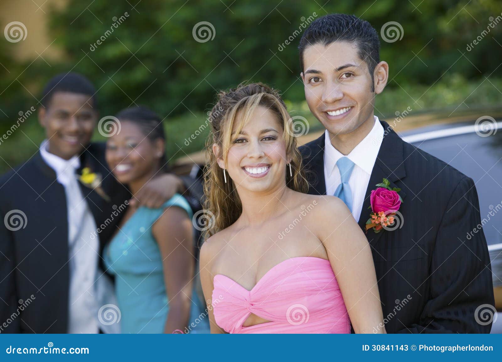 well-dressed teenage couple outside car portrait