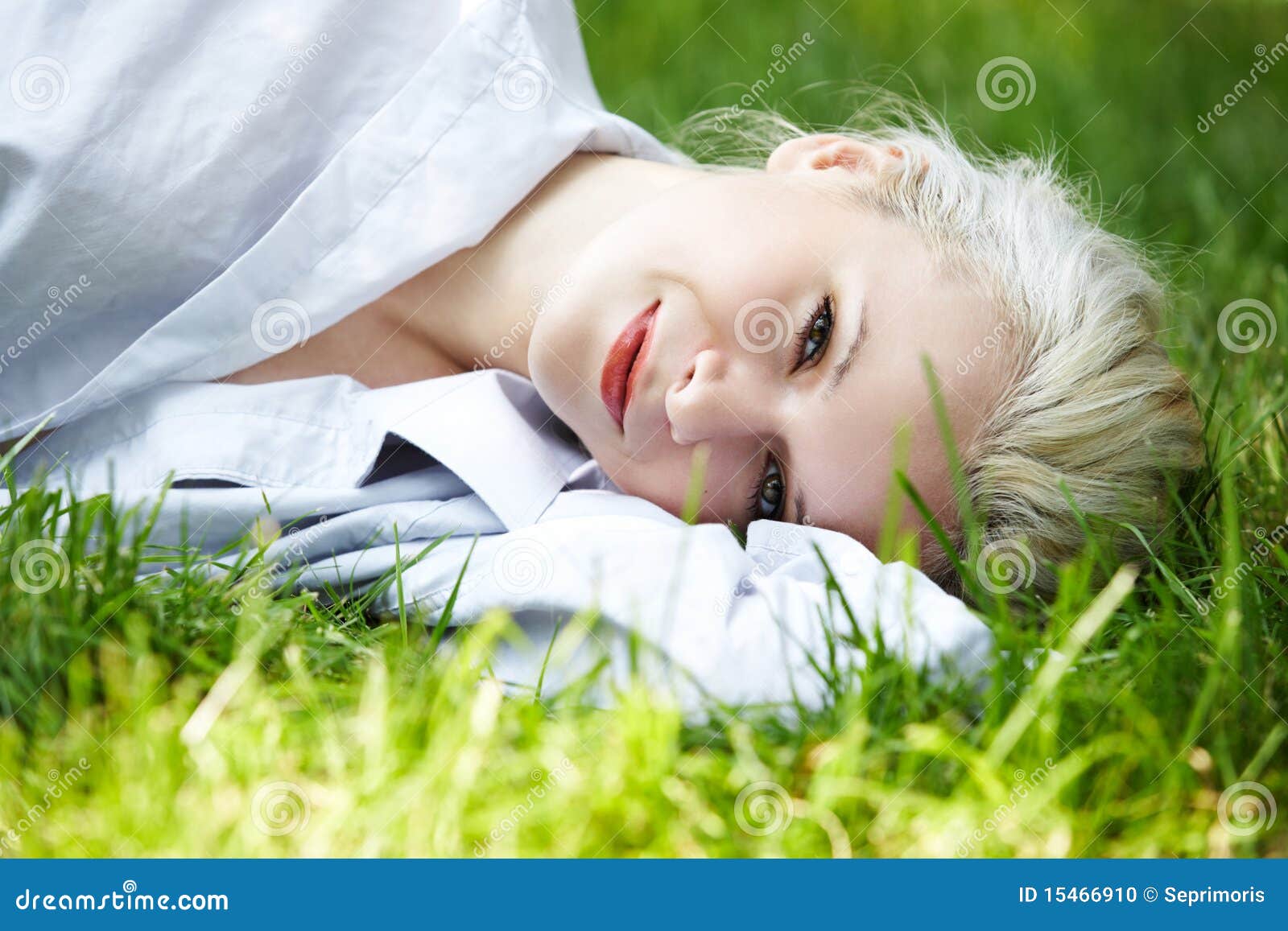 wellbeing. happy smiling woman has rest on grass