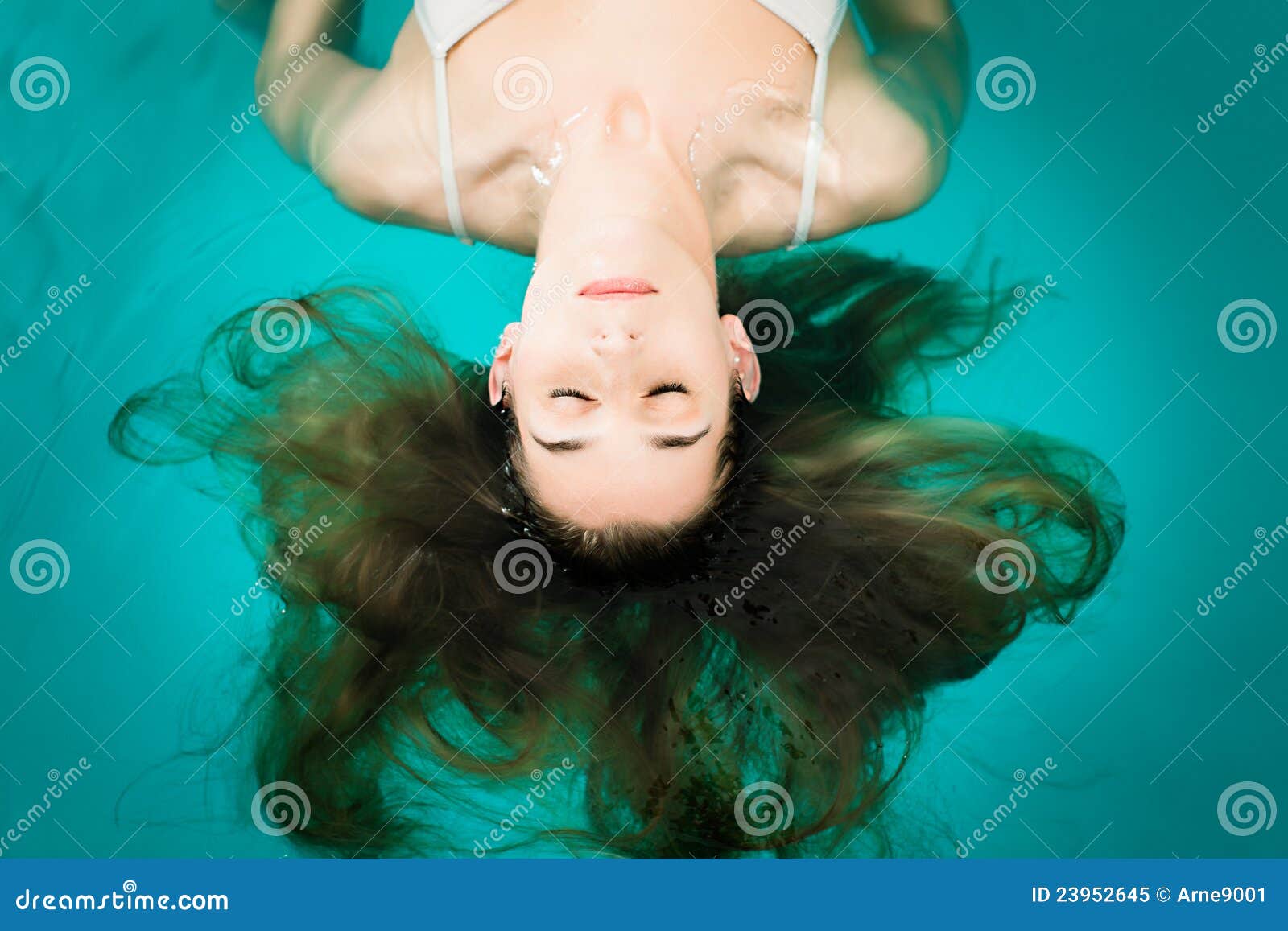 wellness - young woman floating in spa