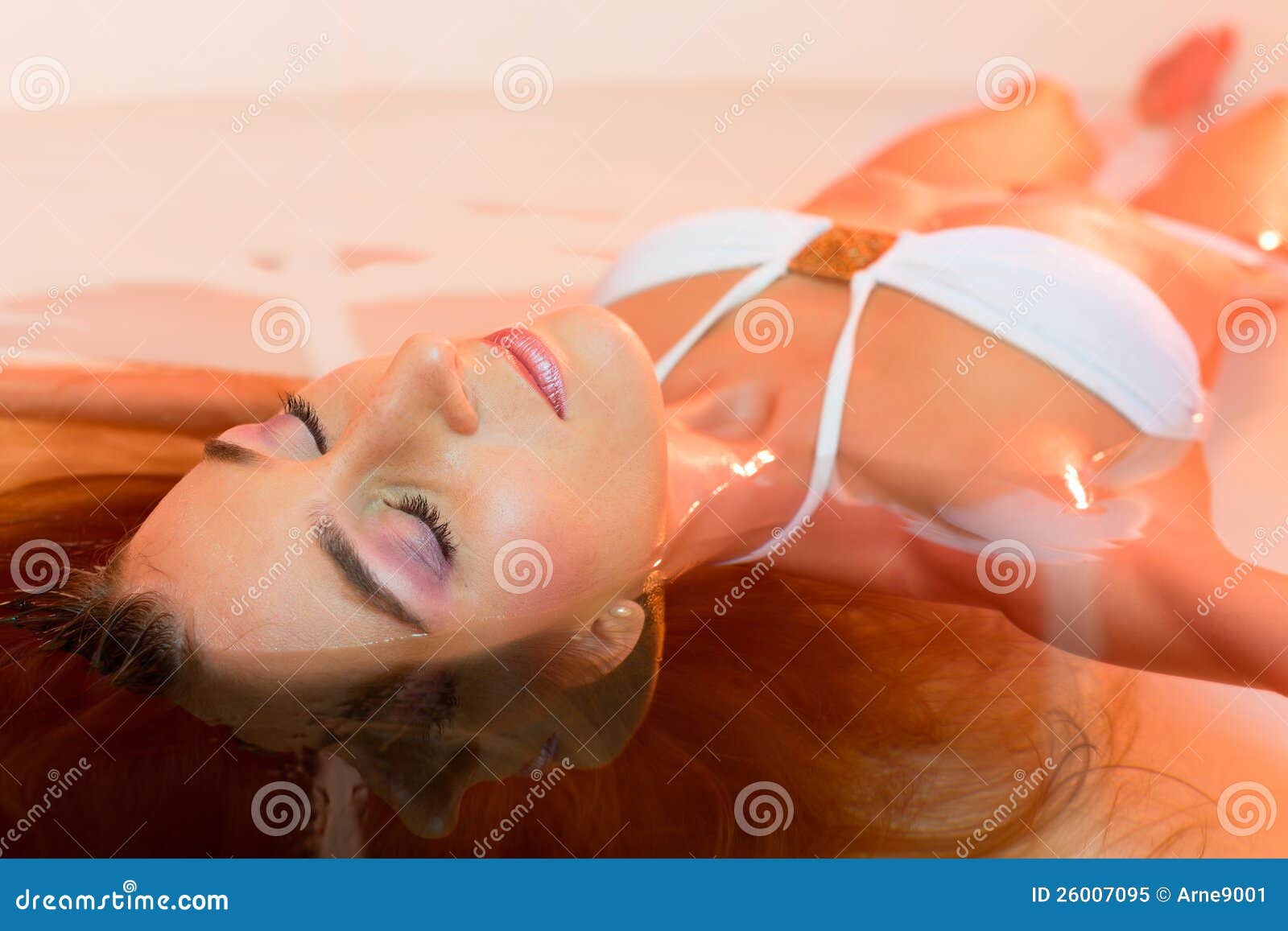 wellness - young woman floating in spa