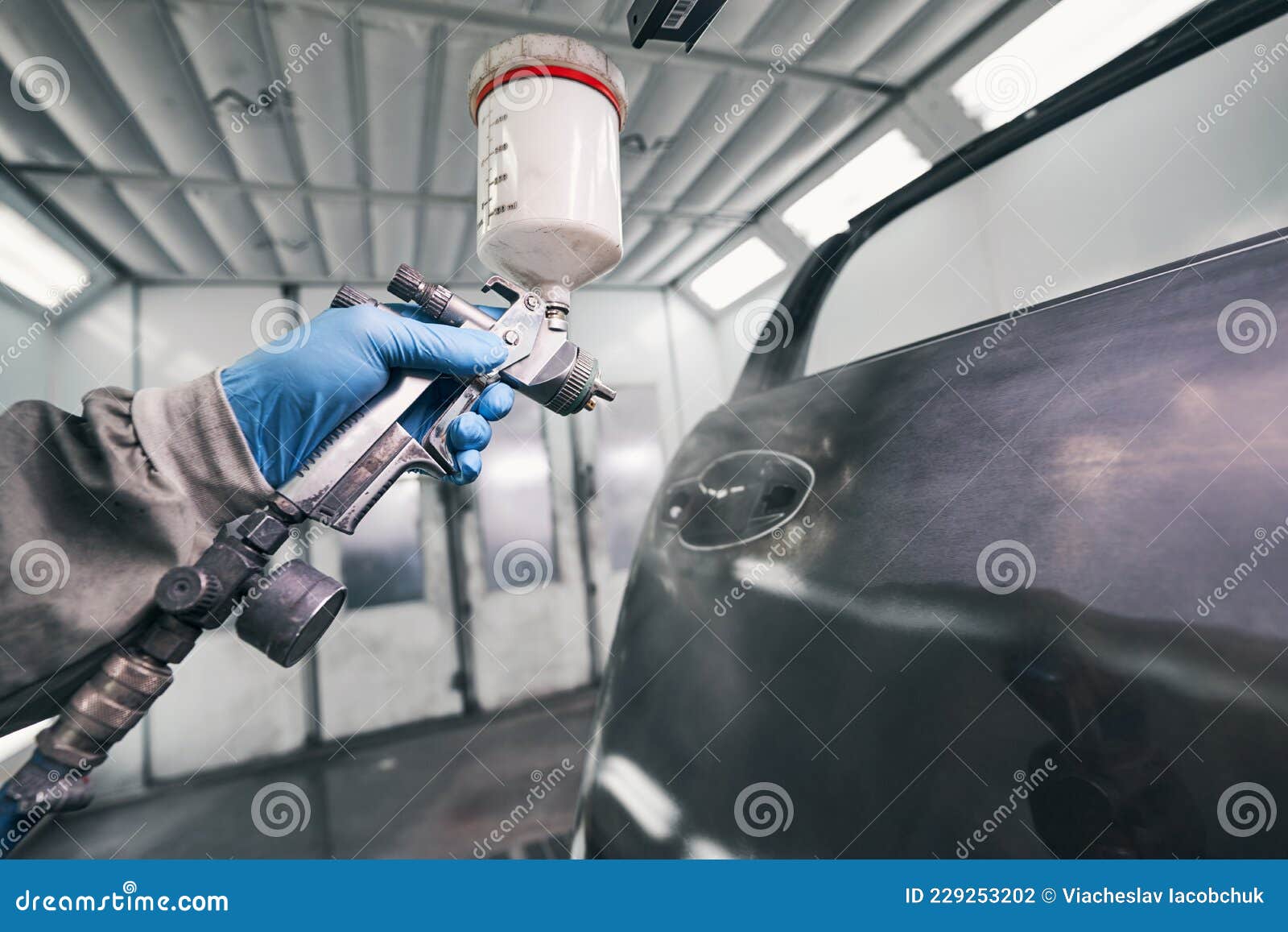 Werkstattarbeiter Bemalen Autotür Mit Spritzpistole Stockfoto