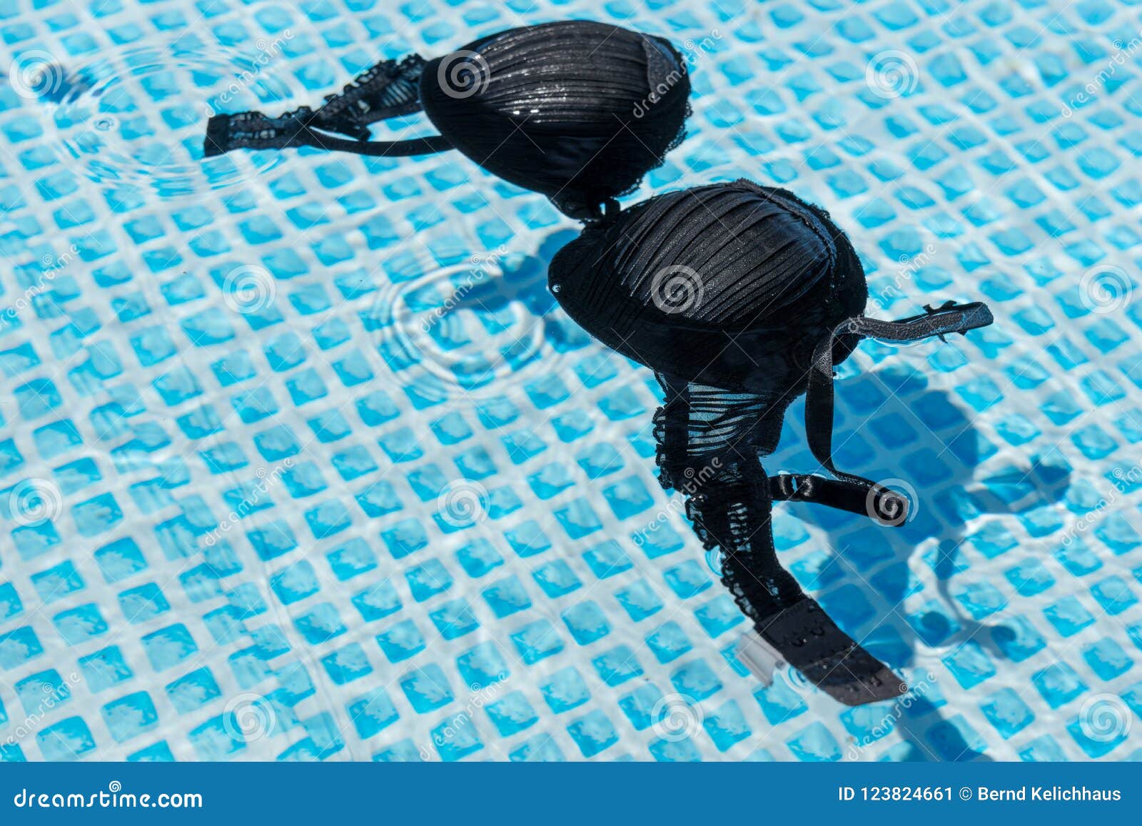 Wet Female Swimsuit Bra or Brassiere Floating in Water of Swimming